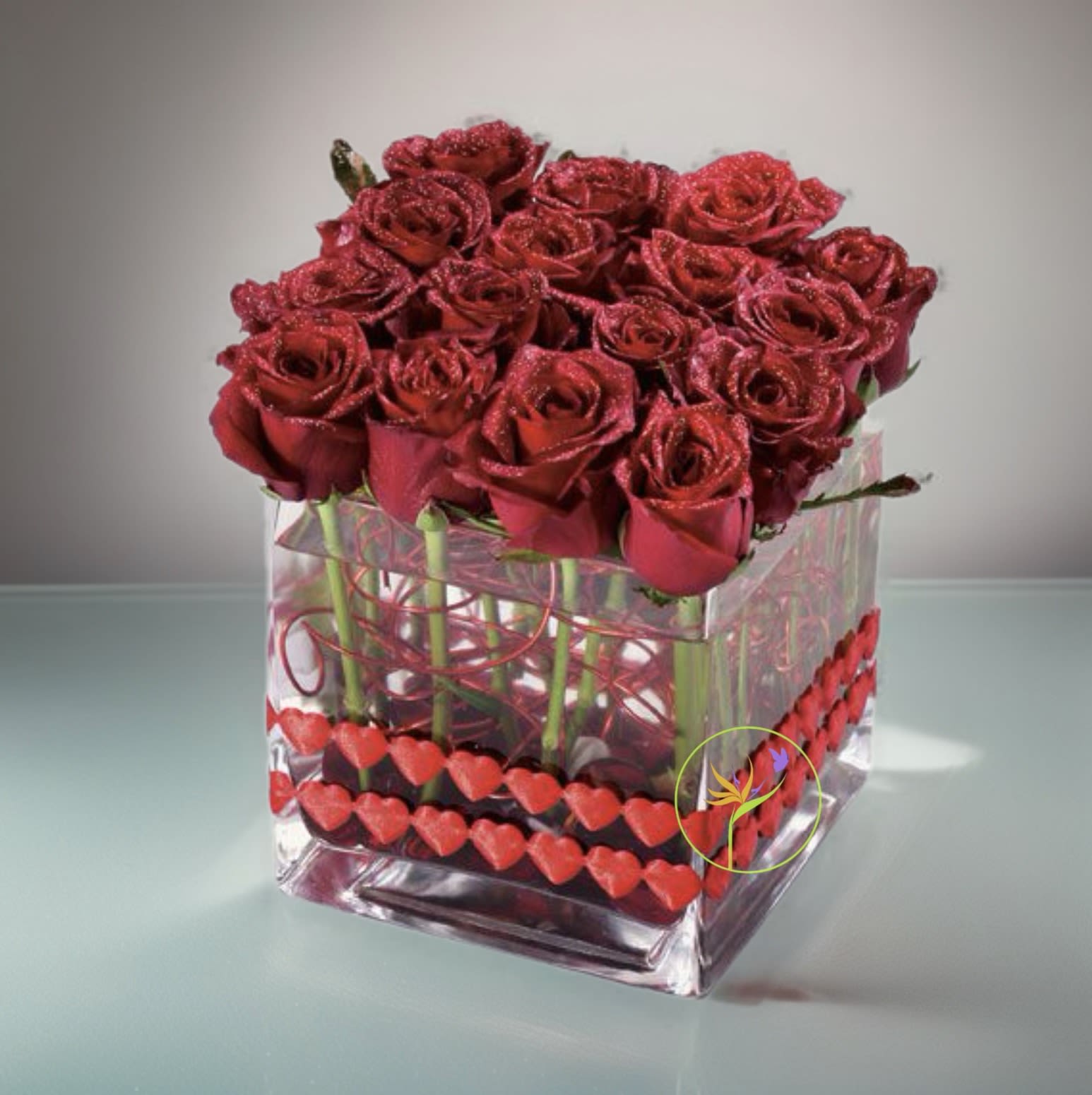 Twelve plus Four.   BN™ - Their heart will beat ever faster when you send this fantastic arrangement of 16 red roses, accented with a beautiful ribbon and florist wire.  NOTE: Our flowers and greens are a gift from nature. It’s shade and depth might vary, design, aesthetic and value remains the same. In support of our efforts to aide in the preservation of our planet, PJf uses Fair Trade flowers, Plants, Upcycled or Recycled containers.