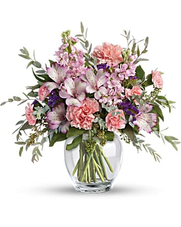 Teleflora's Pretty Pastel Bouquet - Oh so soft and divinely delicate, this perfect pastel bouquet is pretty as can be. Delivered in a classic ginger jar, the graceful arrangement of alstroemeria, carnations and stock is a welcome surprise on any occasion. This pretty arrangement includes lavender alstroemeria, pink carnations, miniature pink carnations, pink stock, purple sinuata statice, parvifolia eucalyptus, and seeded eucalyptus. Delivered in a Clear Glass Ginger Jar.