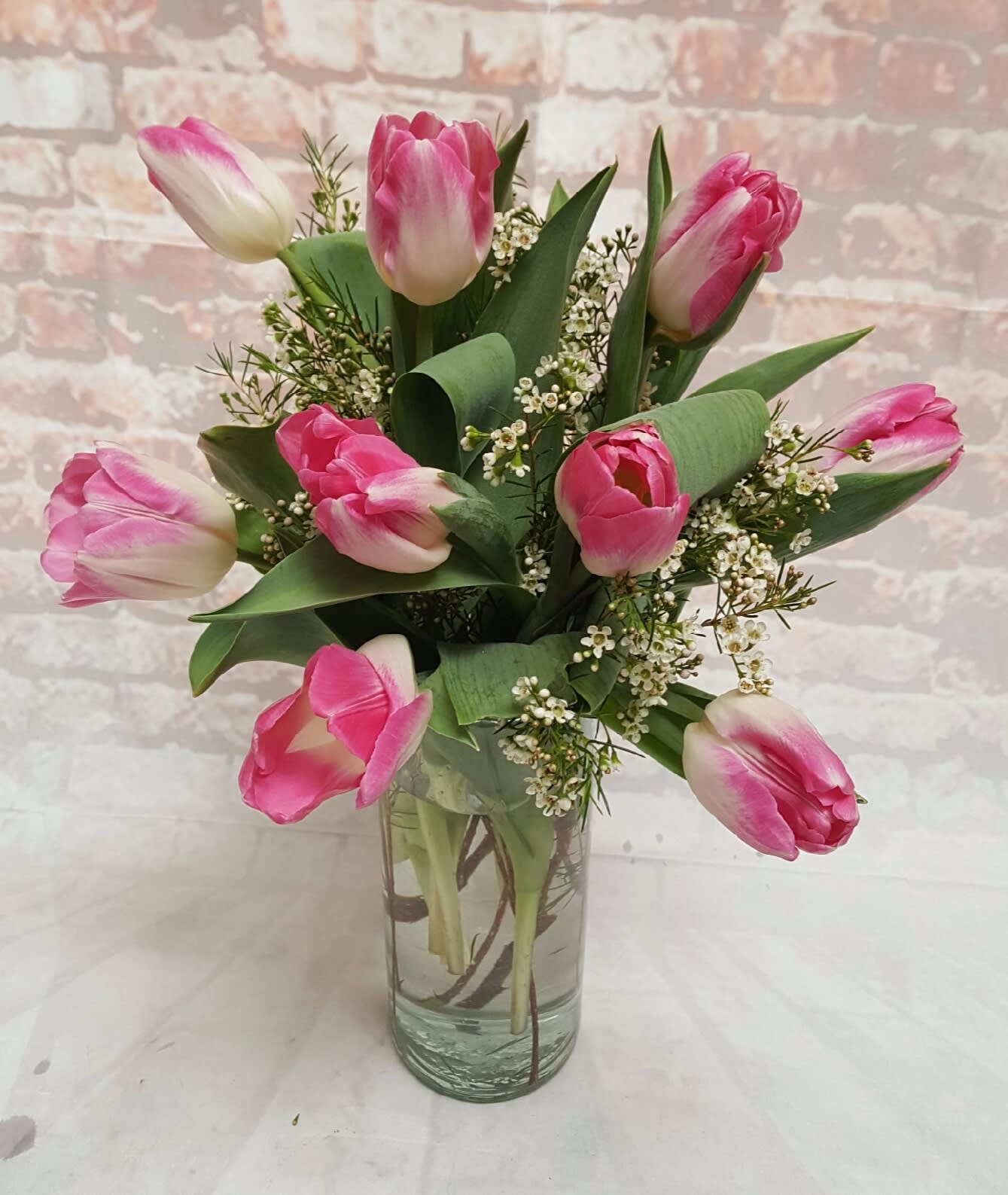 Simply Tulips - Select this clear glass cylinder vase of tulips and filler flowers.  Colors may vary. Call for specific availability or add color requests into special instructions and we will do our best to fulfill. 