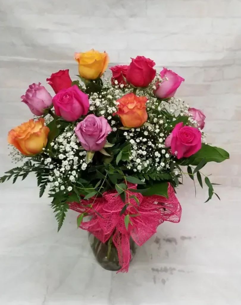Celebration Bouquet - A vibrant celebration of love &amp; joy, this lush arrangement features premium colorful roses accented with delicate  babies breath or wax flower &amp; fresh greenery. Designed in a clear glass vase &amp; finished with a romantic or celebratory ribbon. This bouquet radiates warmth, celebration &amp; happiness!   Perfect for birthdays, anniversaries, congratulations or simply brightening someone's day! The Celebration Bouquet delivers bold color &amp; heartfelt emotion in every bloom.  Standard` 1 dozen roses Deluxe  2 dozen roses Premium 3 dozen roses