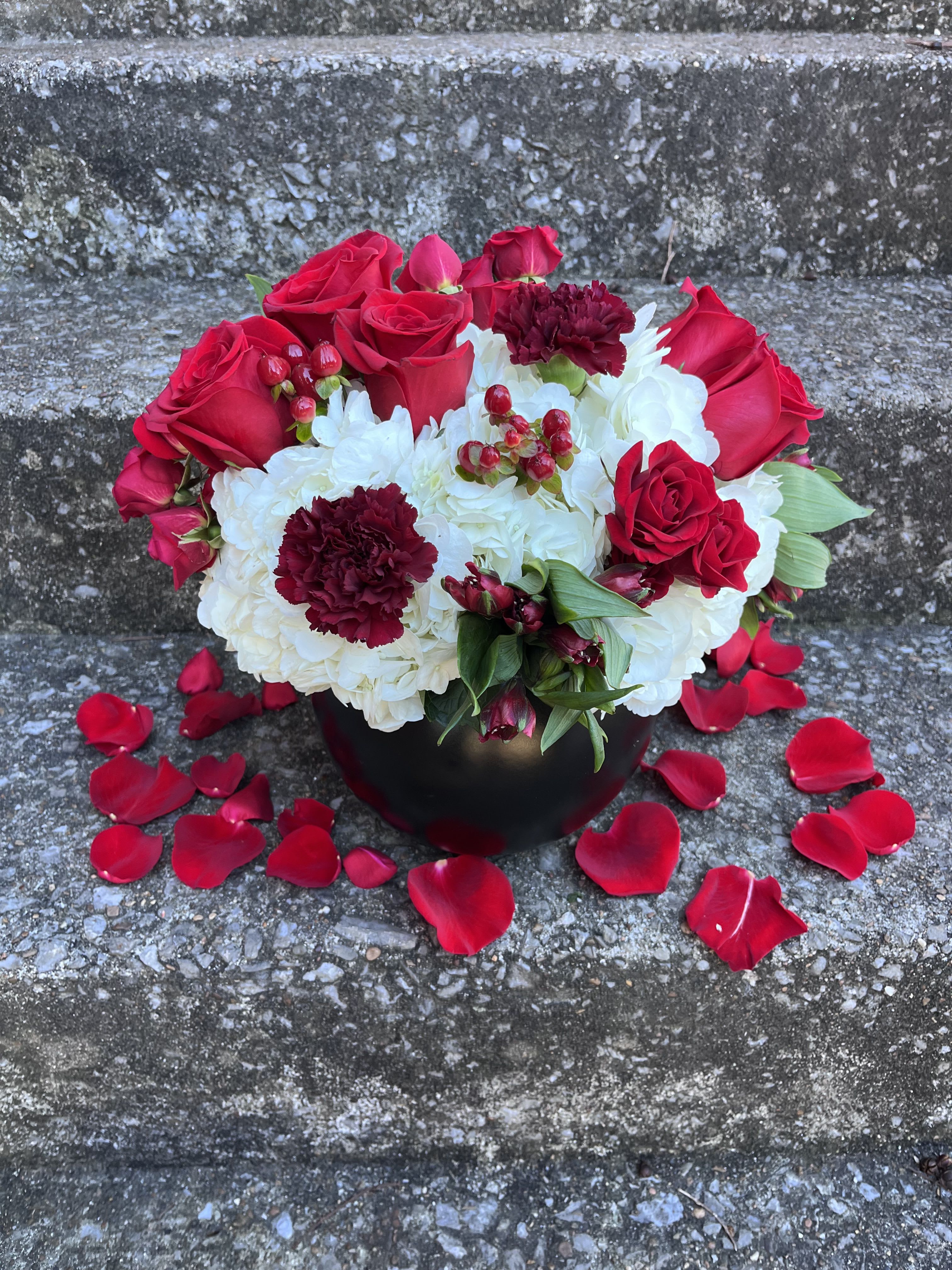 Red Velvet  - This beautifully designed arrangement is filled with hydrangeas roses, alstroemeria, spray, roses, carnations, and hypericum. 