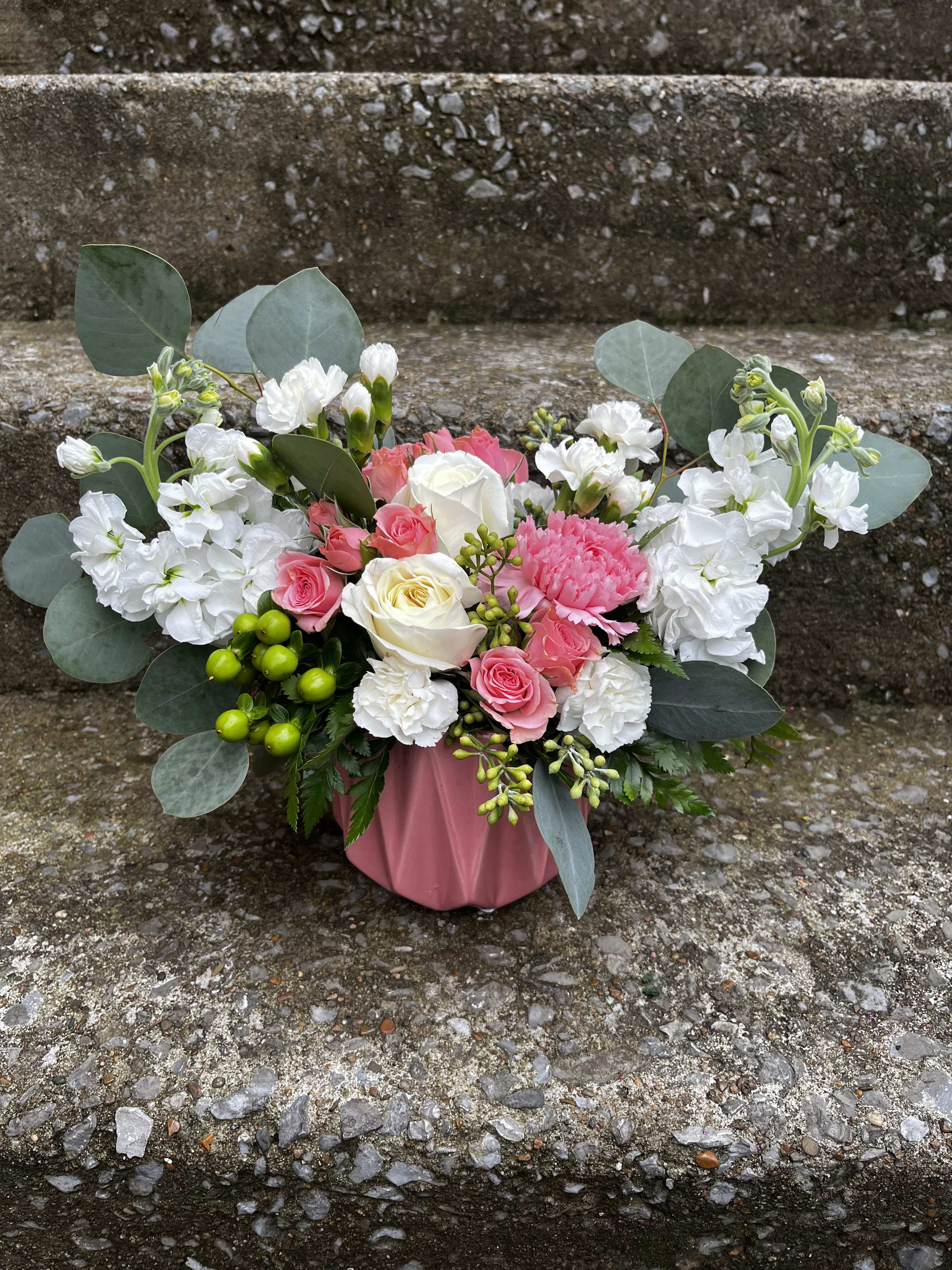 Endless Love - This arrangement has white stock, white roses, pink spray roses, white mini carnations, pink carnations, green hypericum, and eucalyptus.