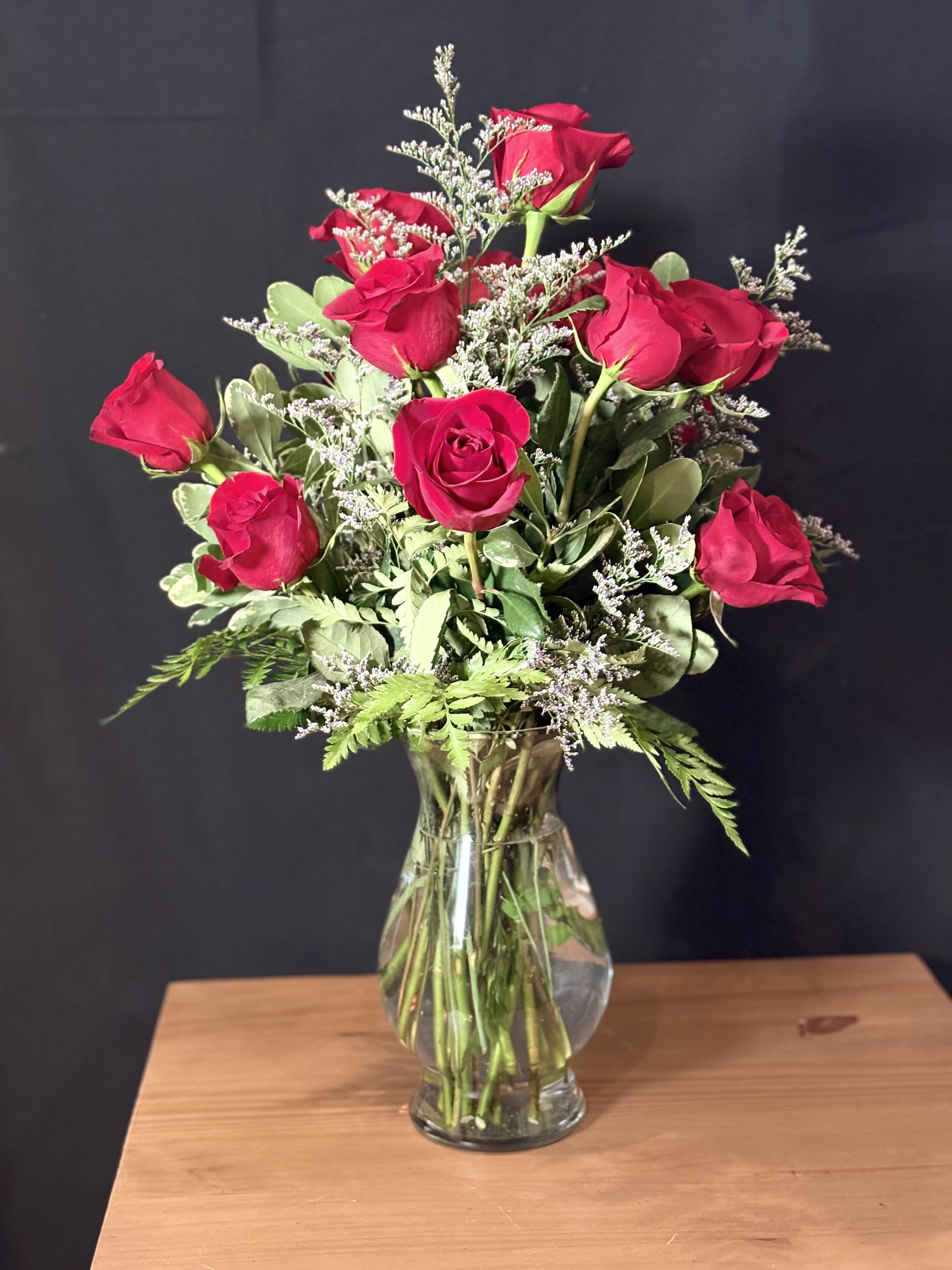 A Dozen Roses - A classic dozen roses, each bloom full and velvety, come together in a timeless display of elegance and romance. Their rich petals unfold with natural grace, symbolizing love, admiration, and heartfelt emotion. Whether deep red, soft blush, or pure white, a dozen roses make a beautiful statement. Simple, meaningful, and unforgettable.