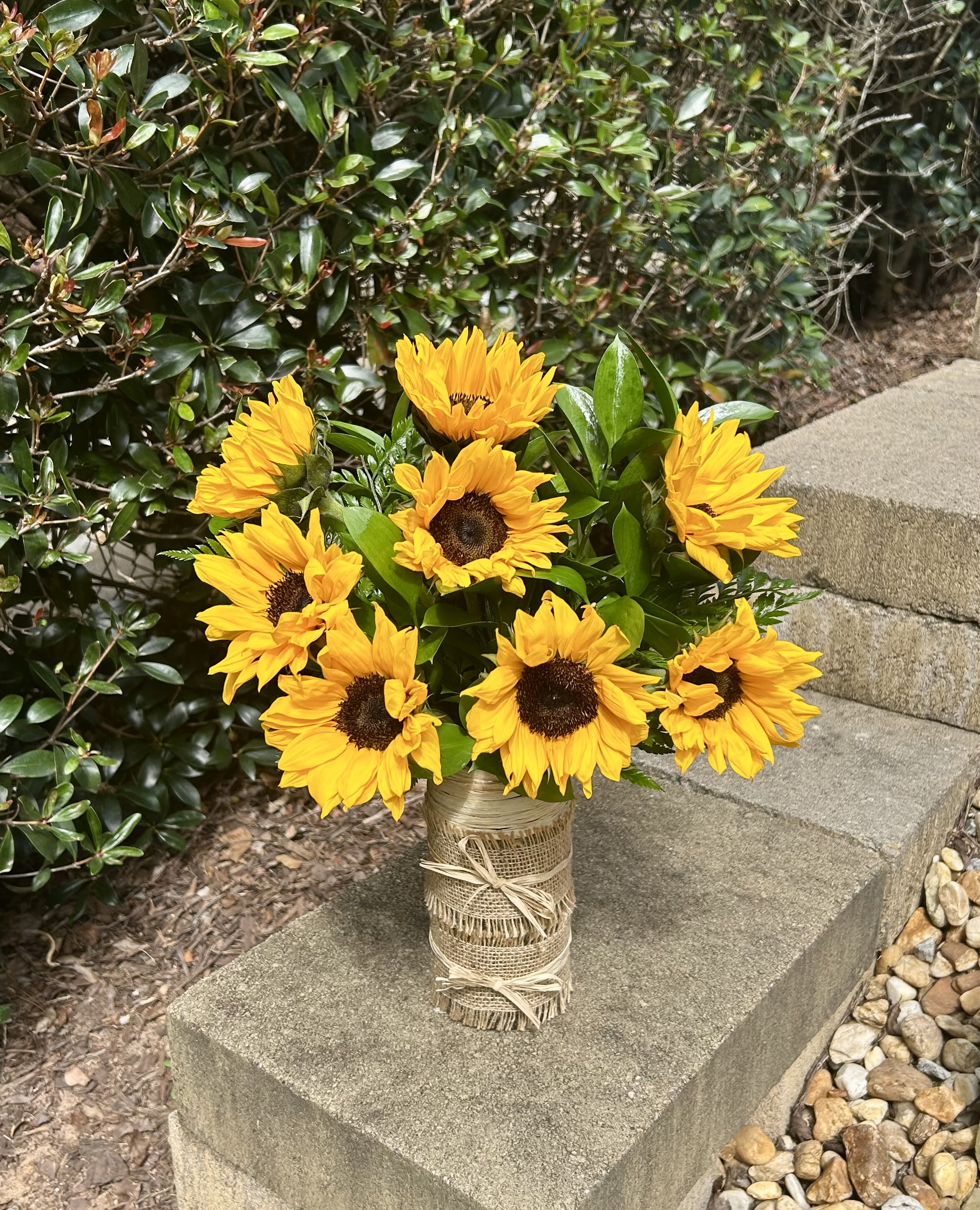 Sunny Delight - This cheerful arrangement of bright, golden sunflowers brings warmth and positivity to any occasion. Wrapped in rustic burlap, the bouquet evokes the beauty of sun-kissed fields and the joy of a sunny day. Perfect for sending a smile or brightening up any room, the "Sunny Delight" bouquet is a timeless expression of happiness and love. Whether it’s for a birthday, anniversary, or just to make someone’s day, this radiant display will surely leave a lasting impression.