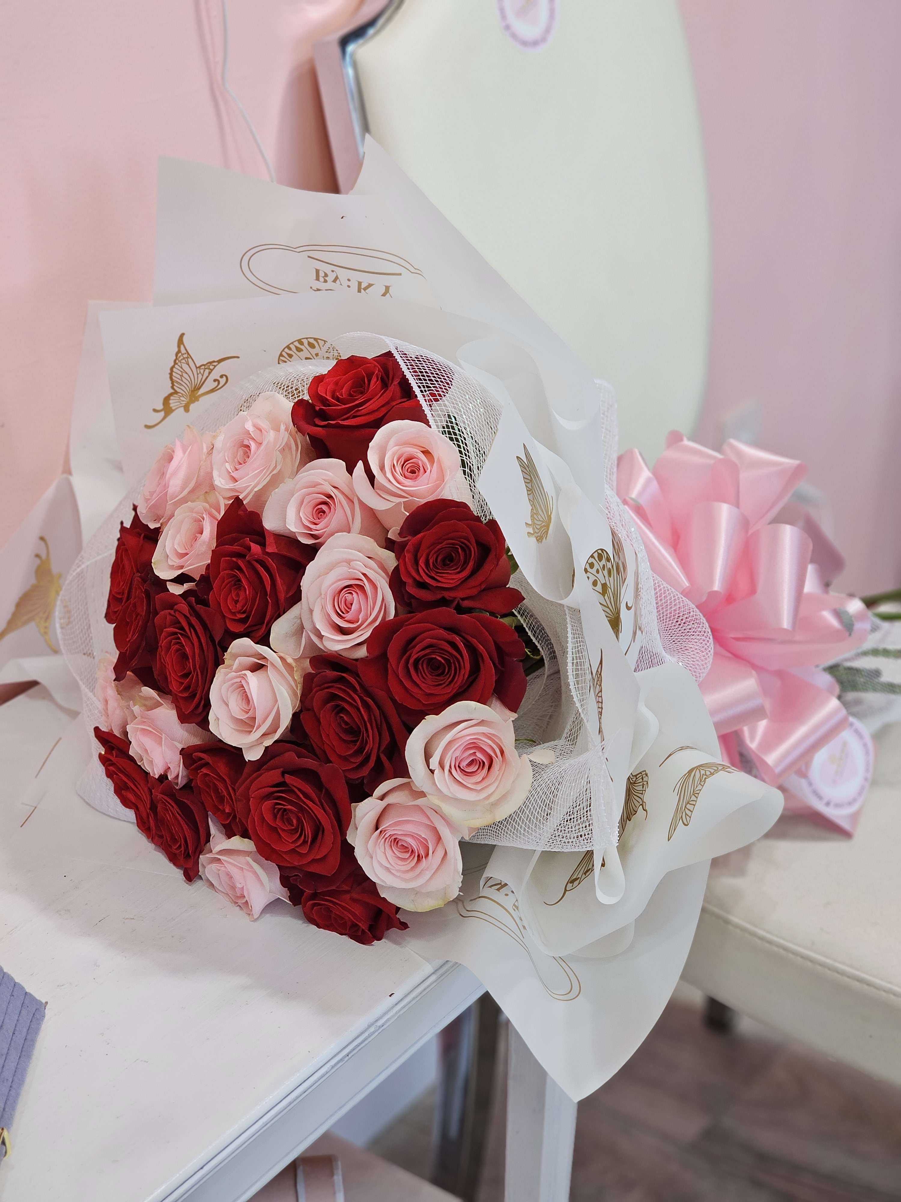 Mini Hand Bouquet - Express your LOVE for that special person in your life! This mini hand bouquet has 25 default red and pink roses. For other colored roses, please leave us a note on your order!   "Explore our designer’s choice arrangements, where our expert florists craft stunning, fresh floral designs tailored to your preferences and the season. Perfect for any special occasion—birthdays, Valentine’s, anniversaries, or just because—these unique bouquets highlight creativity, quality, and thoughtfulness."  “Explore our beautiful Mini Ramo Buchon arrangement perfect for any occasion,  birthday, just because, Valentines, Im sorry, I love you arrangement. Fresh, vibrant flowers designed to bring joy and beauty. Available for delivery in Dodge City, surrounding areas, and beyond.”