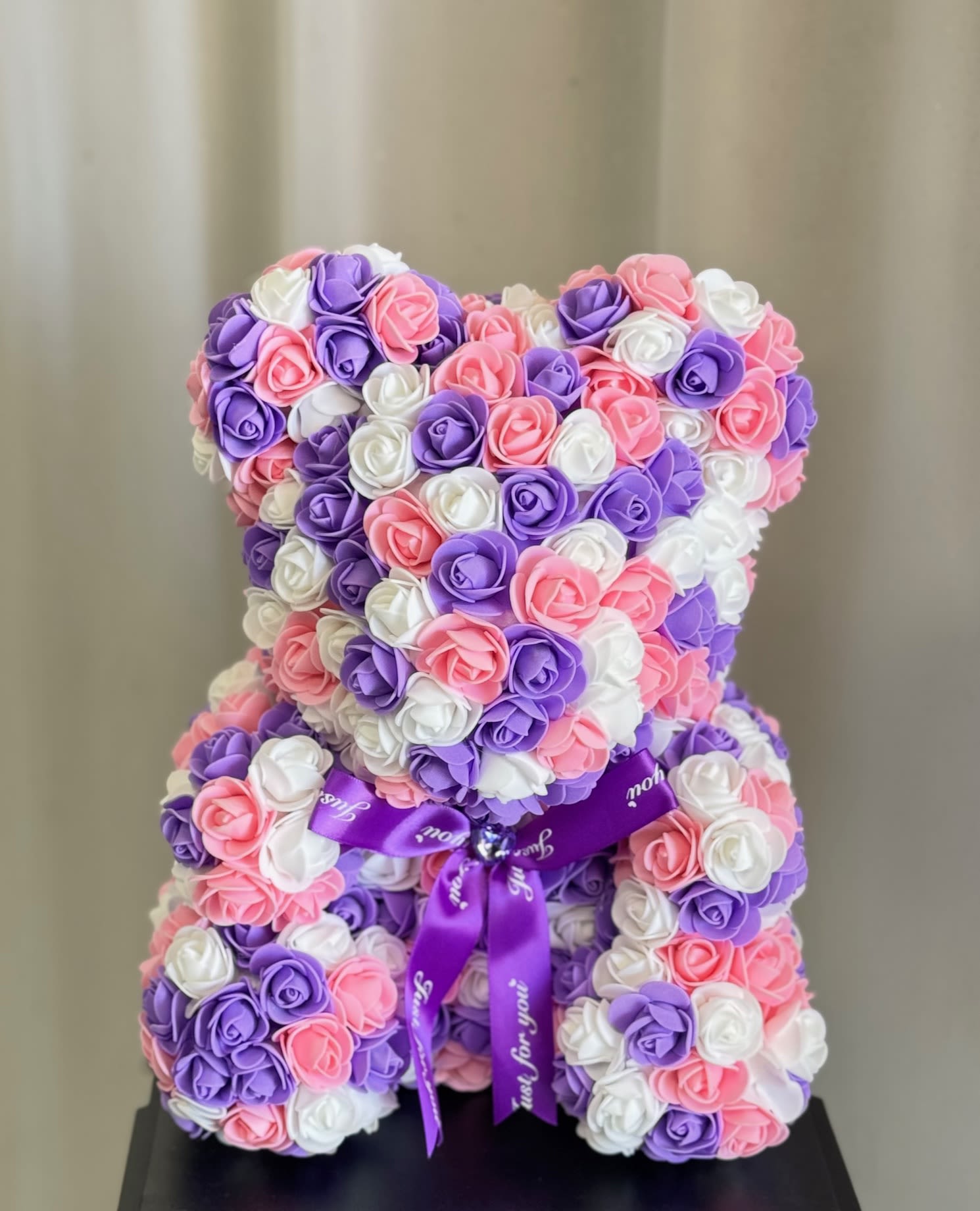  Faux Lavender, Pink and White Rose Teddy Bear - Each lovely, Styrofoam, Rose Teddy Bear is 100% handmade and covered with soft, faux, rose petals that are individually added. Each bear arrives in a window display box that is 15 in height and 11 in width, perfect for sitting on a shelf or table. They're designed to be durable and will last a lifetime if handled with care. They make a beautiful and eye-catching decoration in any room or even at the office. Every time she looks at it, she'll remember that special day. What a sweet memento!  Bear Dimension: 13" H x 10"W 