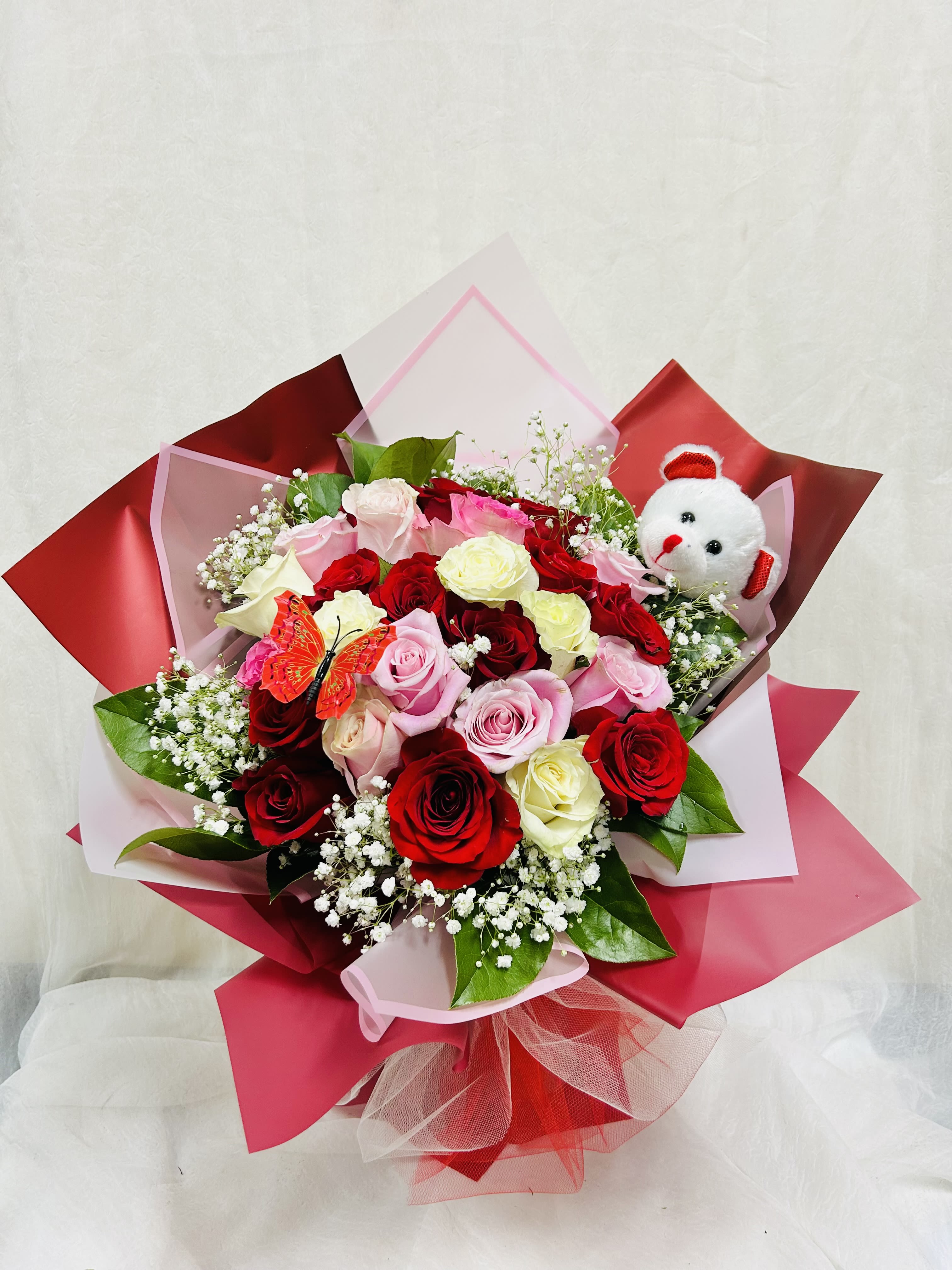 Can't Bear Without You - Beautiful bouquet featuring red, white, and pink roses, baby breathe, and green accents. 