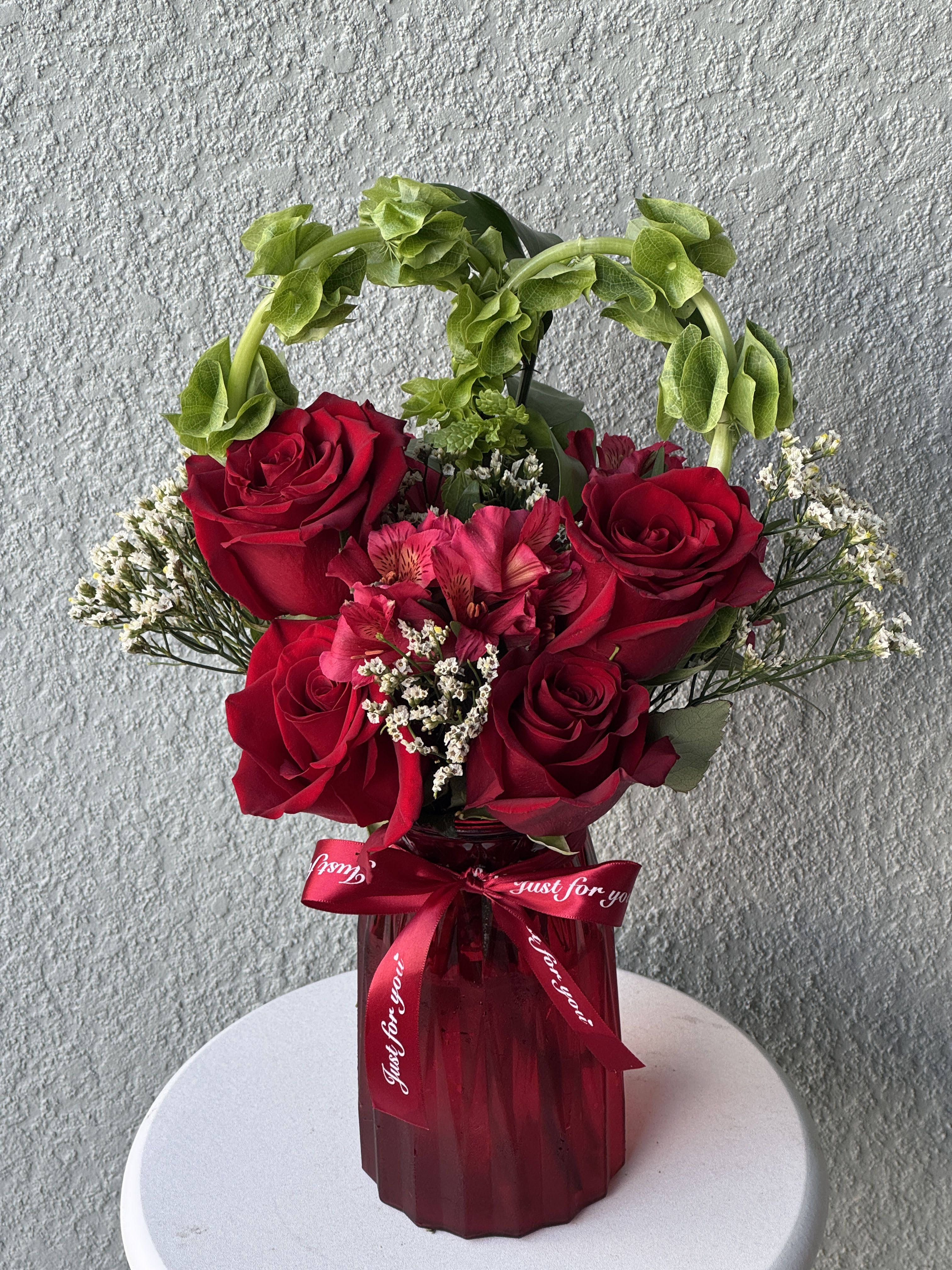 Bliss of Love  - Fall in love with Heart of Emerald Bliss a luxurious display of passionate red roses framed by a heart of lush Bells of Ireland. Elegant, romantic, and unforgettable. 