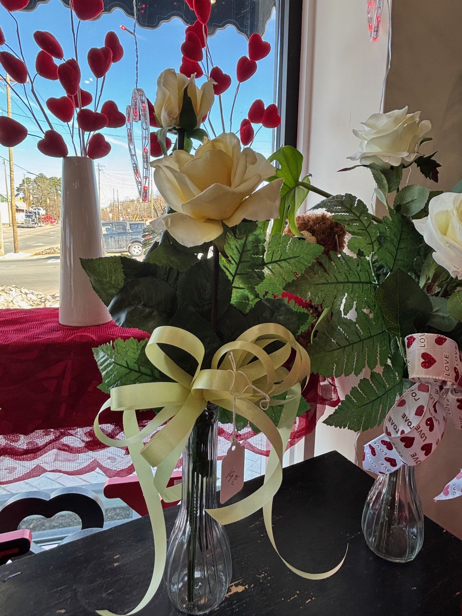 2 artificial creamy yellow rose budvase - A pair of creamy yellow artificial roses in a simple bud vase, perfect for a charming and lasting accent.