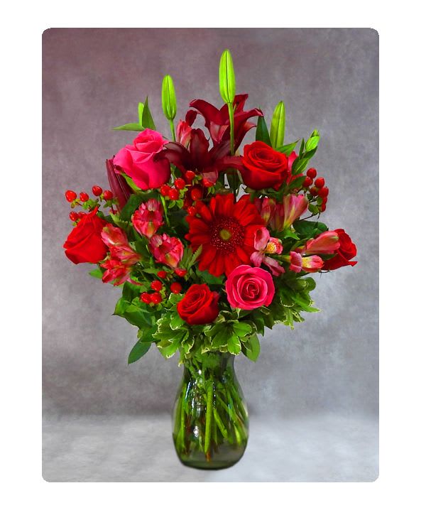 The Red's Vase Bouquet - Bold and beautiful vase of all shades of red. Designed with roses, gerbera daisies, hypericum berry, alstromera and more.