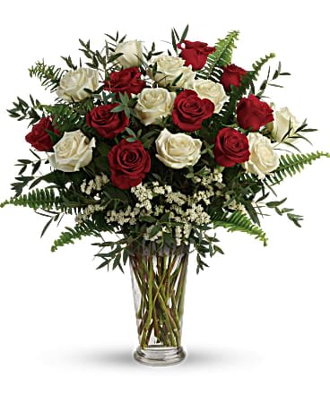 Yours Truly Bouquet - Make your special someone feel truly loved by surprising them with this extraordinary bouquet! A dozen and a half red and white roses are artfully arranged in a classic vase with delicate greens. This bouquet includes red roses, white roses, white sinuata statice, parvifolia eucalyptus, and sword fern. Delivered in a clear romanesque vase.