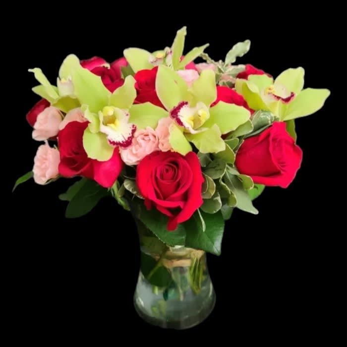 Truly Adored  - This arrangement includes green cymbidium orchids, pink spray roses, and 1 dozen red roses. Truly Adored by is a romantic gift for Valentine's Day, birthday, or anniversary.   APPROXIMATE DIMENSIONS: 16" H X 13" W