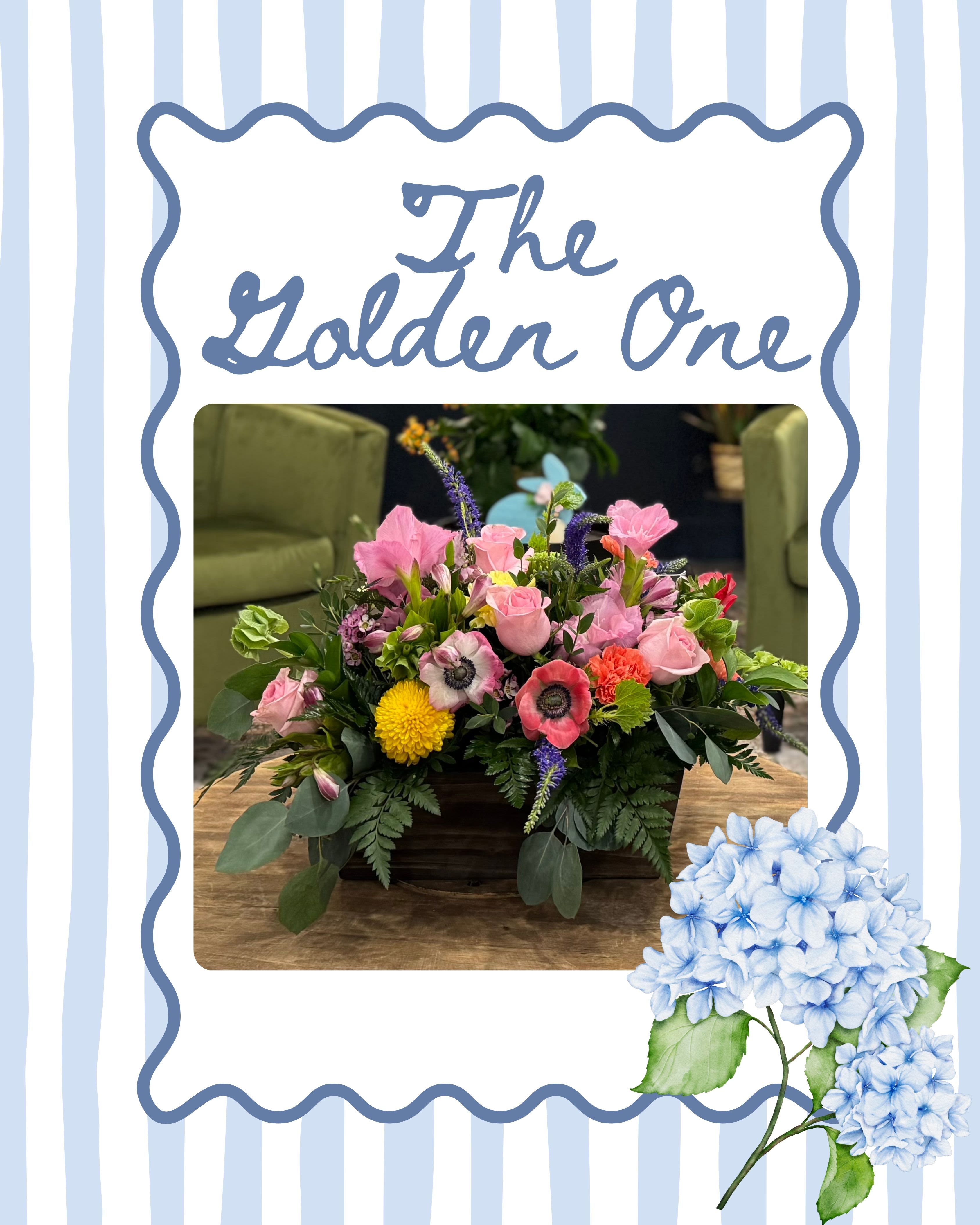 The Golden One - The Golden One features a lush mix of premium seasonal blooms in soft pinks, fresh greens, and cheerful golden tones. Designed low and full in a rustic wooden container, this arrangement feels warm, garden-inspired, and effortlessly elegant. Perfect for celebrations, gratitude, or brightening any space.
