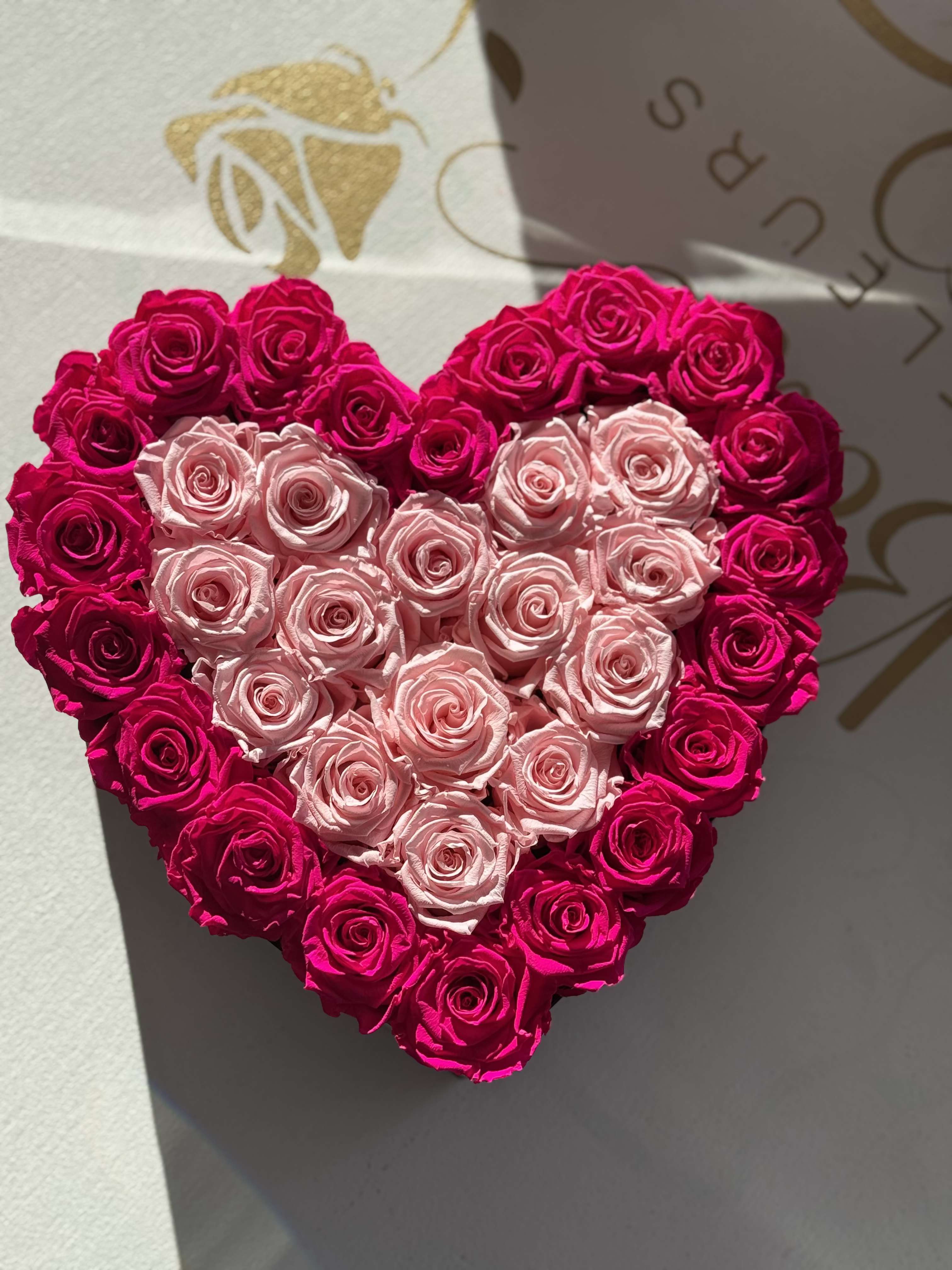 Heart Forever Roses (Hot Pink with Light Pink in the middle Roses with Black Box) - Forever roses nestle in our Signature Boîte in the shape of a heart that is sure to WOW any recipient. Give the gift that lasts forever!
