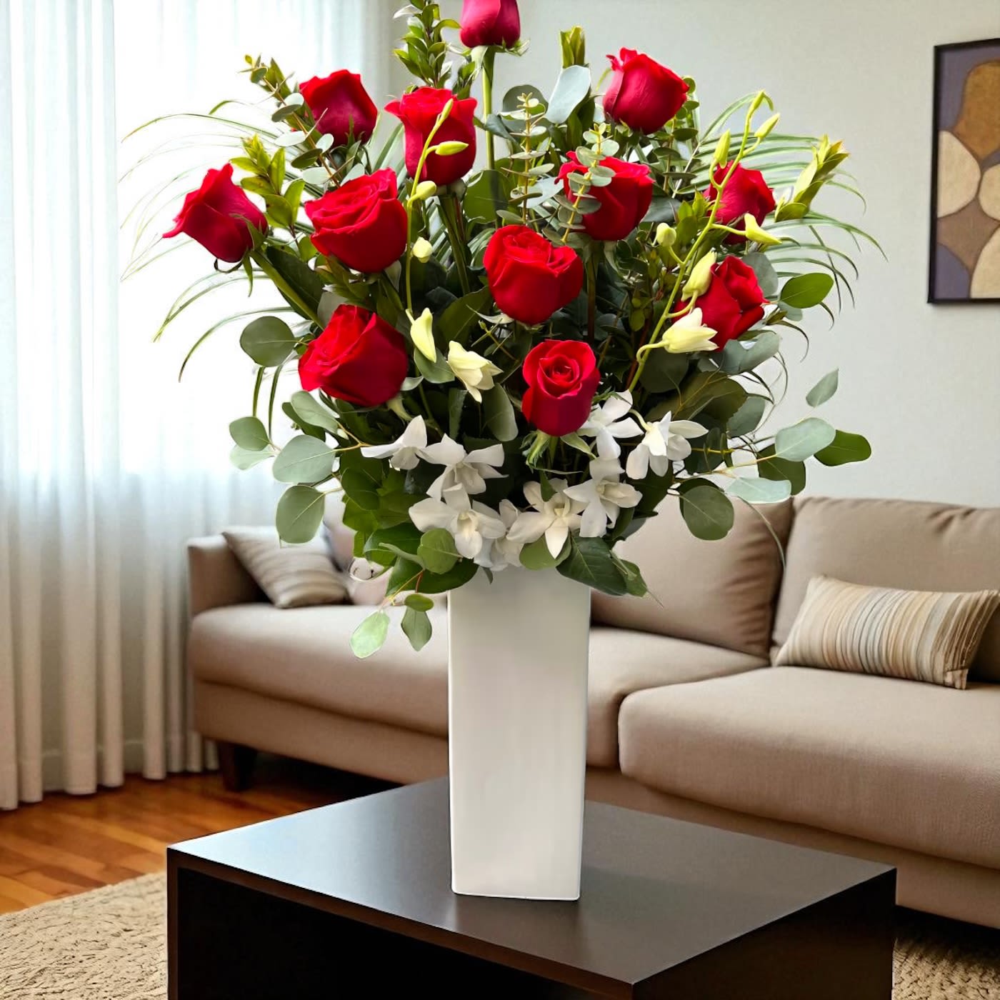 Eternal Romance  - Celebrate timeless love and sophistication with our Eternal Romance Vase, a breathtaking display of premium long-stemmed red roses. Accented with lush greenery and delicate white blooms, this grand arrangement is designed in a tall, modern white vase that exudes elegance from every angle.  Perfect for anniversaries, Valentine’s Day, romantic celebrations, or luxury gifting, the Eternal Romance Vase captures the essence of passion and refinement. Handcrafted with care by the expert designers at Bloom in Glory Florist in Orlando, each rose is carefully selected for its velvety texture, vibrant crimson hue, and long-lasting beauty.  Available for same-day flower delivery in Orlando, Wedgefield, Winter Park, Lake Mary, Maitland, and across Central Florida, this luxury rose arrangement is the ultimate way to make a bold and unforgettable statement of love.