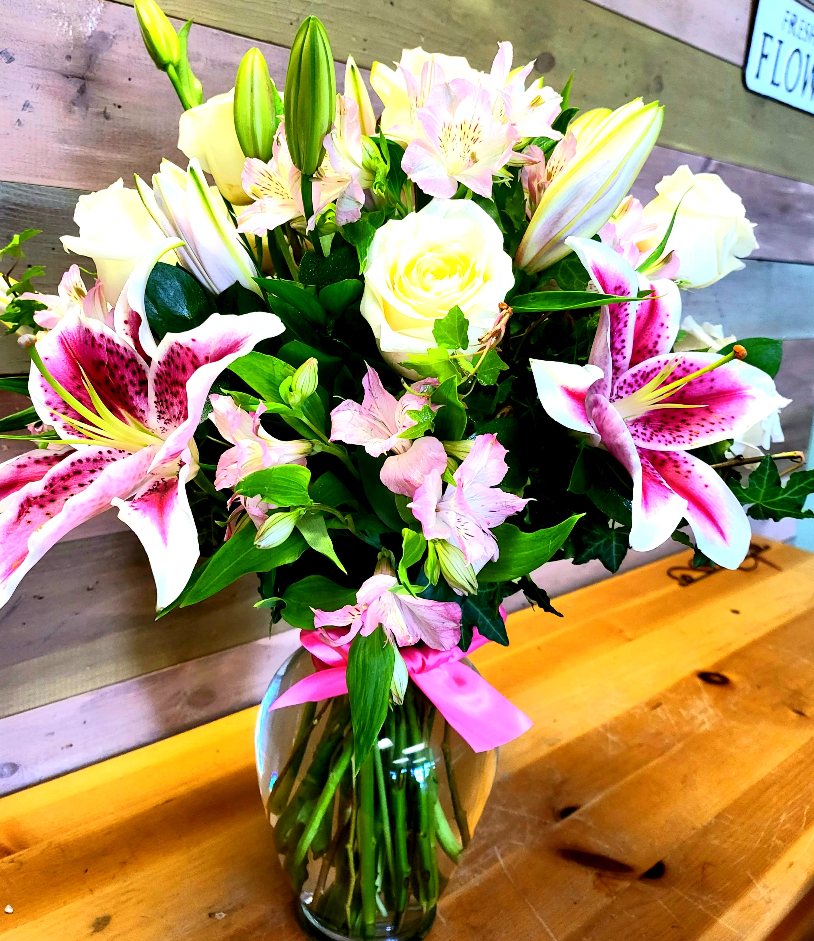 Stargazer in Love - Assortment of stargazer lilies and a mix of roses. All roses are subject to change with a in stock availability.