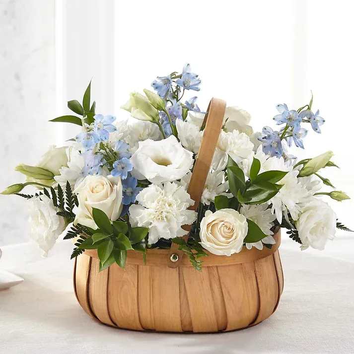 Sincerely Heartfelt Basket - Fresh blue and white flowers are designed to share your heartfelt thoughts for the loss of a loved one. Our talented designers beautifully craft roses, lisianthus and delphinium to create the loving sentiment that is sent with our Sincerely Heartfelt Basket.  Details The Premium Basket is approximately 14"H x 18"W. Designed by florists, ready to display. For long–lasting blooms, add water daily.