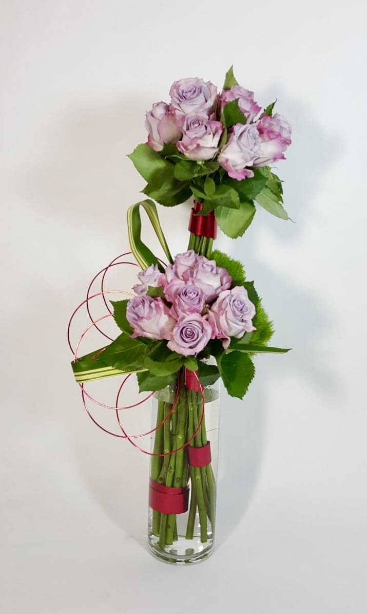 Lavender Bunches - Modern Floral Arrangement of Fresh Cut Premium Long Stand Roses in a Glass Vase, with Tropical Greens, and Color Wires. Available in other colors. White, yellow, red, and Pink 