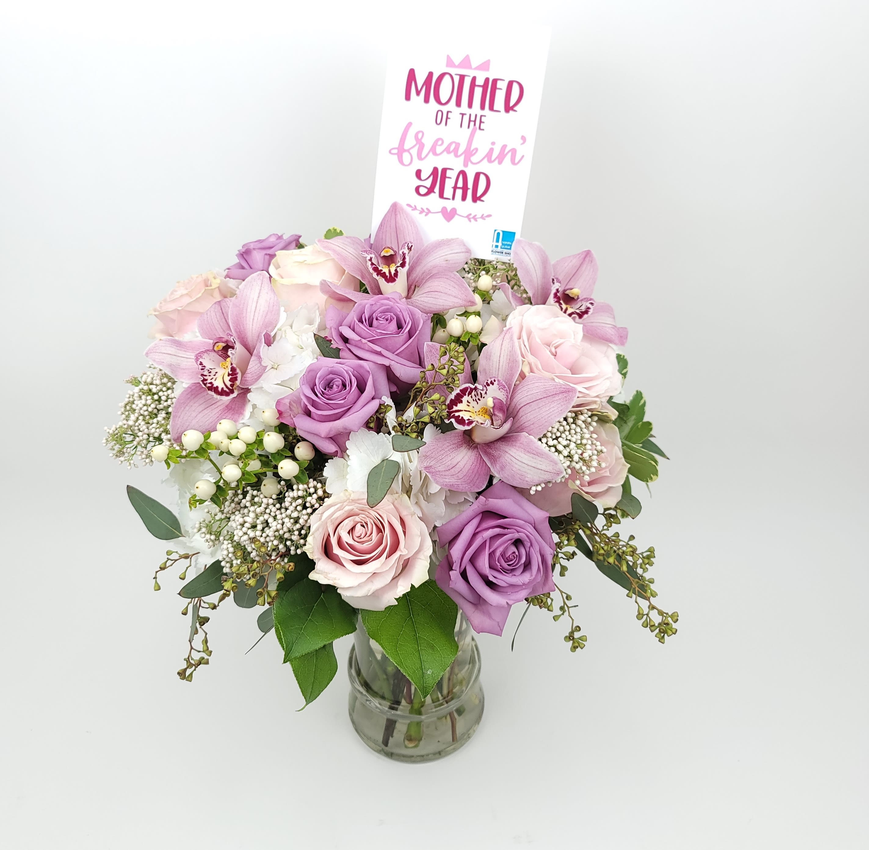 Mother of the freaking year - In a clear vase an arrangement with roses, hydrangeas,  cymbidium orchids, and fillers.