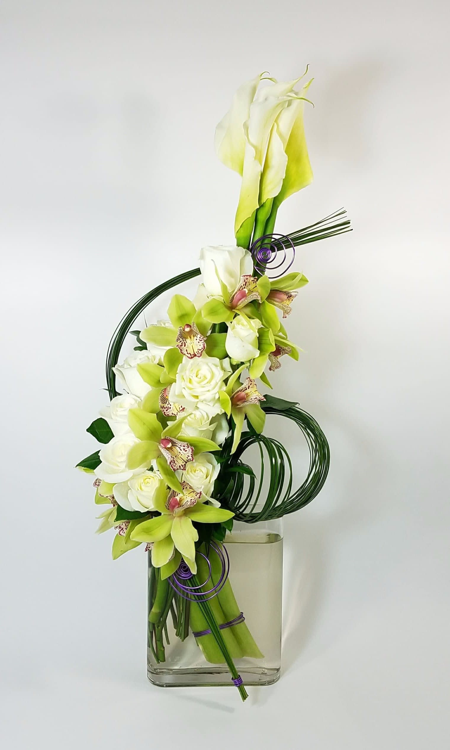 Nefertiti empire - White Callas, Green Cymbidium Orchids, White Roses, Flexi Grass.  Approximately 30" H by 15" W