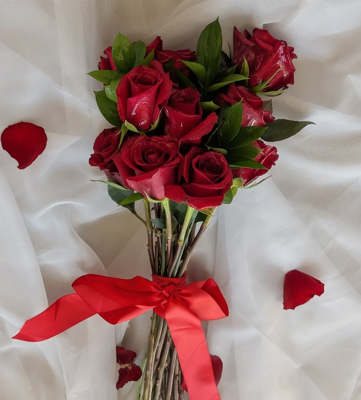 Modern Red Rose Hand Bouquet-One Dozen - The perfect mix of classic and modern. One dozen romantic long stemmed roses beautifully wrapped with a red satin ribbon. 