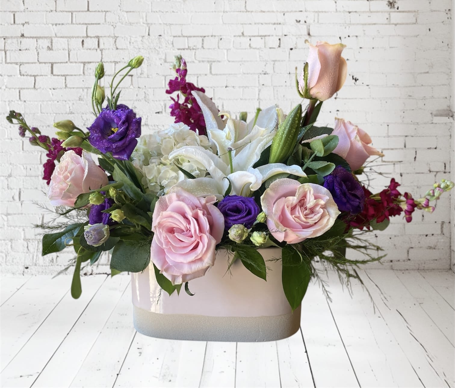 Cotton Candy Dreams - This arrangement includes white hydrangeas, pink roses, white lilies, purple lisianthus, and magenta stock.