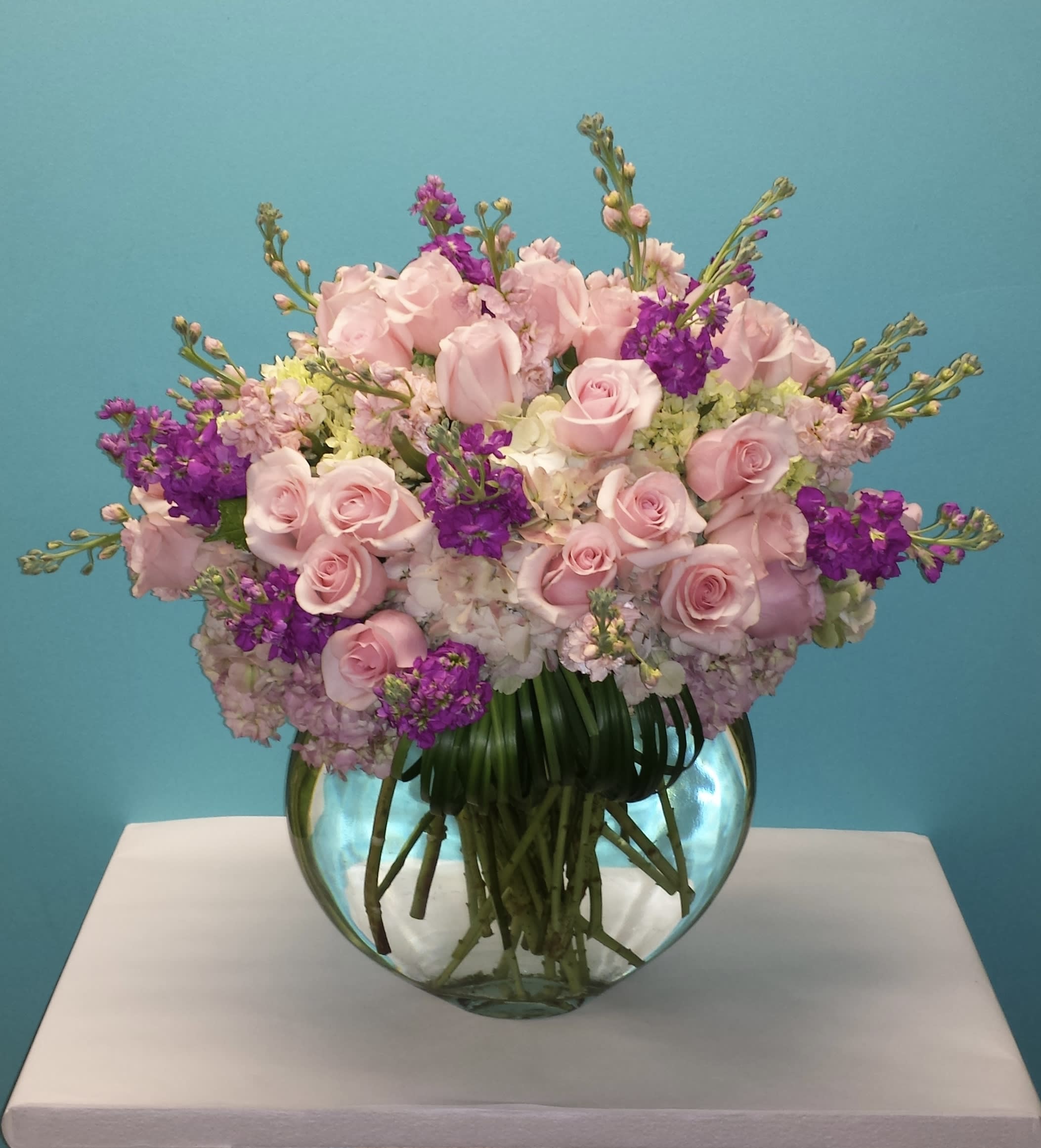 Light Royalty  - Clear bubble vase full of roses, stock &amp; hydrangeas 