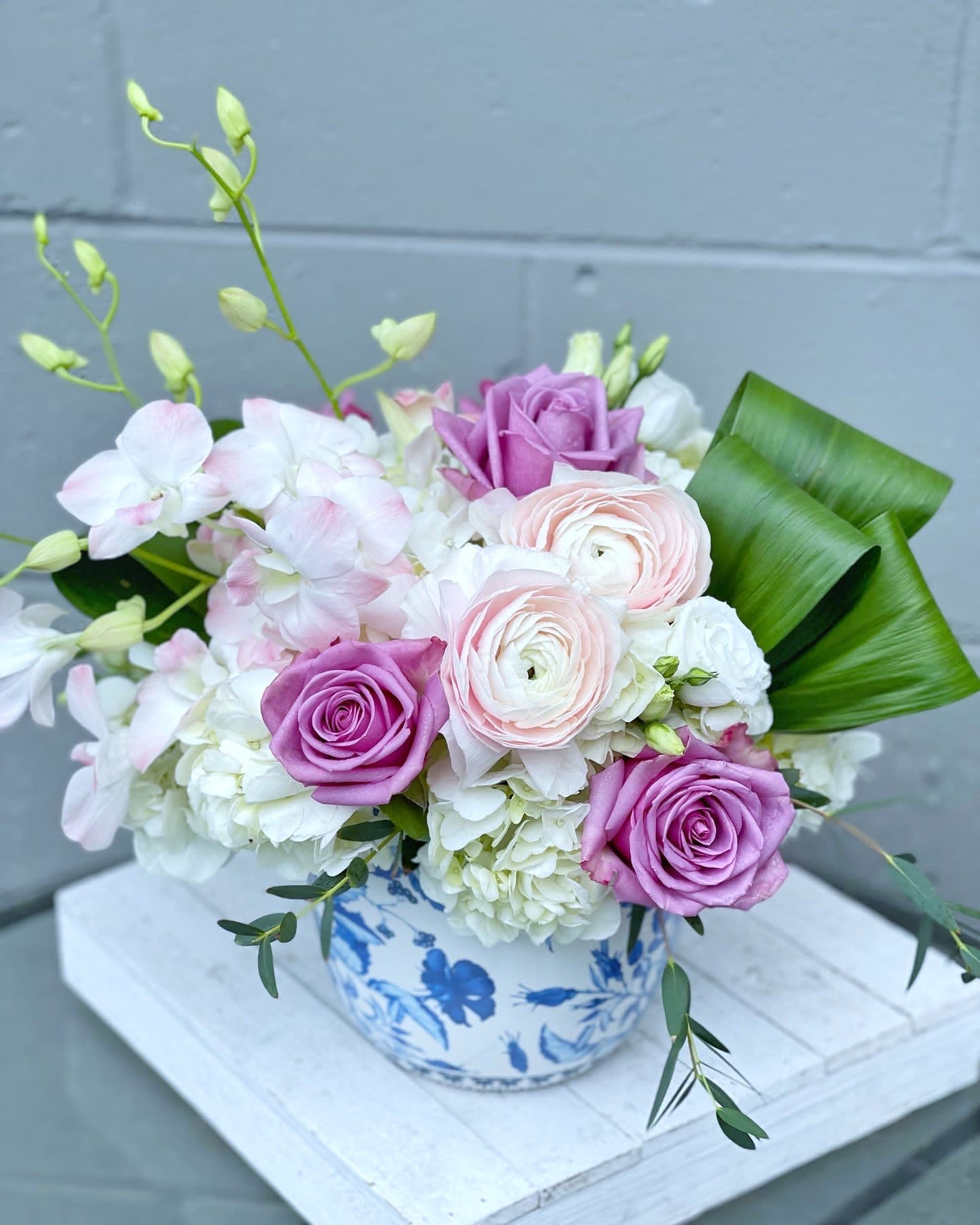 Paris  - The Paris is a Limited Collection Mother's Day arrangement designed on a beautiful blue floral luxe vase.   - Delicately arranged by our professional florists with Hydrangevaas, Roses, Dendrobium Orchids, Ranunculus, and other blooms. - Careful selection of the freshest flowers available (Shade may vary due to availability). - To guarantee the longevity of the flowers, some may arrive in bud or close form and will fully bloom over the next few days.