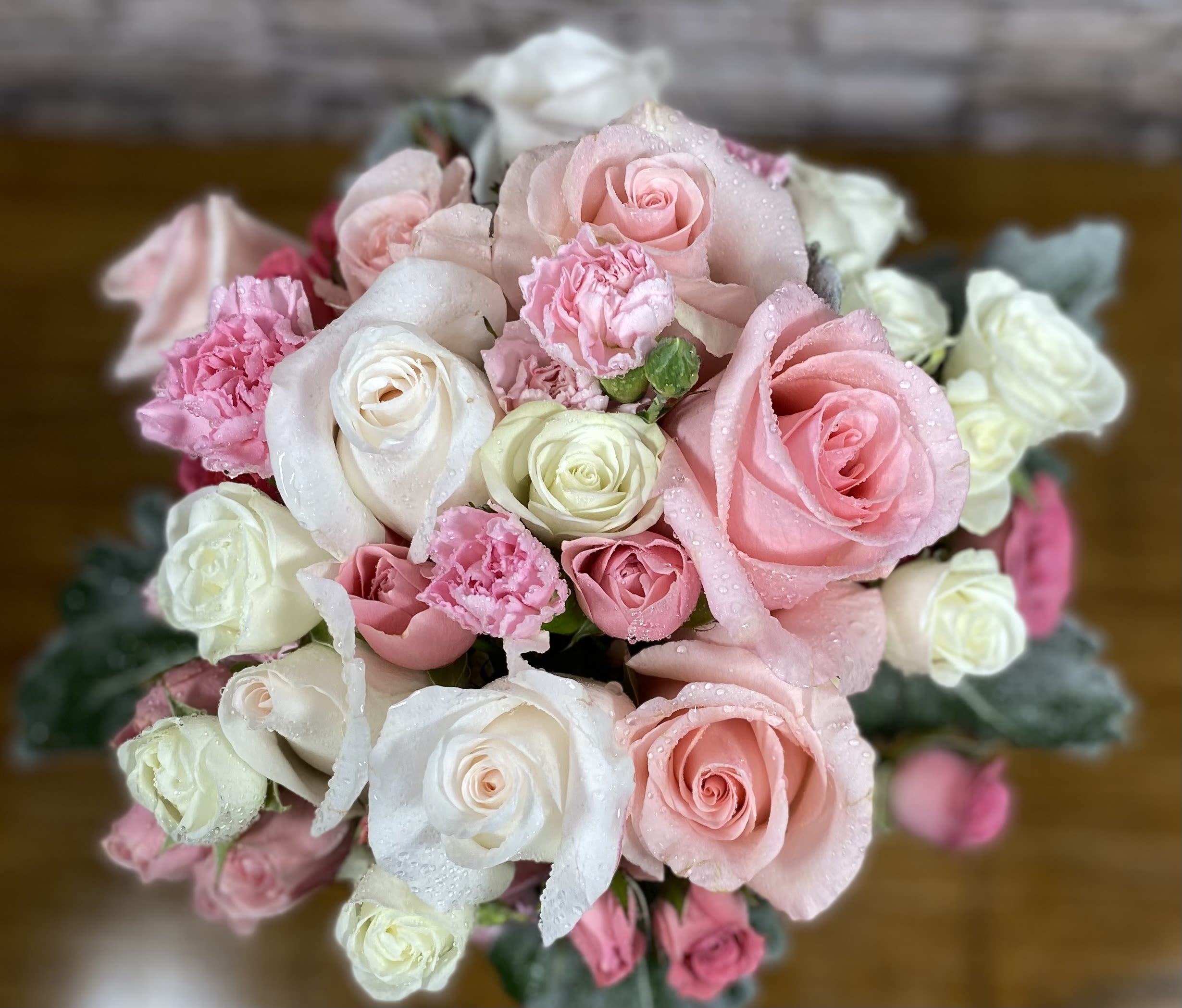 Sophia's Sweet Blossoms - An assortment of pink and white roses, spray roses with complementary flowers in a gathering vase. This would be a perfect choice for a New Baby Girl, Breast Cancer Awareness, Valentine's Day, Mother's Day or Just Because.