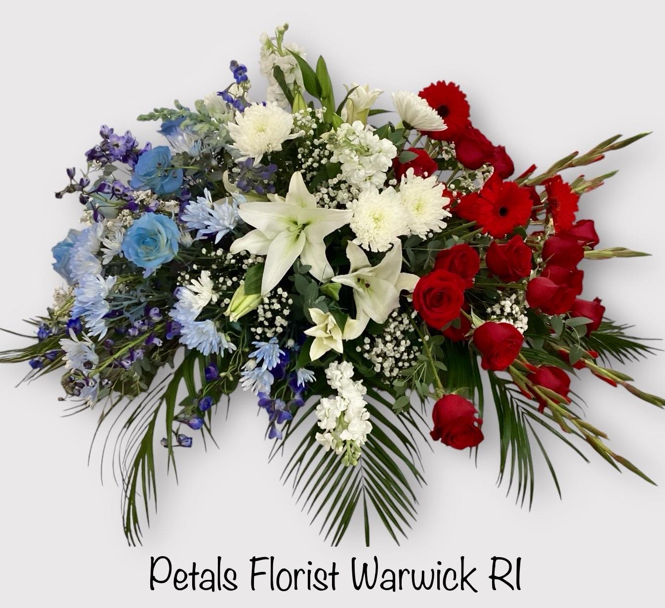 Patriotic Casket Spray/Blanket Red White Blue by Petals - Please allow 24 to 48 hours for this design so I can deliver your flower on time. If you need immediate delivery, contact me at 401-828-0701 for a telephone consultation today.   Honor your loved one who proudly served our Nation with a beautiful large Patriotic Casket Spray for their celebration of life memorial service. Designed with a beautiful array of Red, White, and Blue Flowers. Some flowers may vary due to daily availability. Please call me at 401-828-0701 if you have a special request. Thank you, Cheryl