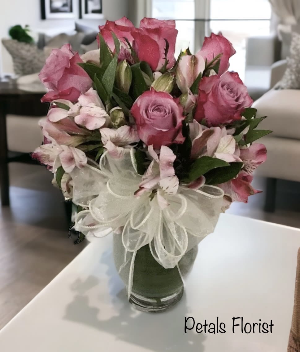 Peruvian Lilies &amp; Roses by Petals -  Experience the lasting beauty of our premium rose and Peruvian lily arrangement. Often likened to orchid blooms for their exciting diversity, alstroemeria adds vibrant, long-lasting color and signifies devotion, prosperity, and fortune. For different rose color options, please contact Cheryl directly at 401-828-0701 to confirm daily availability. We appreciate your understanding that specific flower color shades may vary due to stock availability.