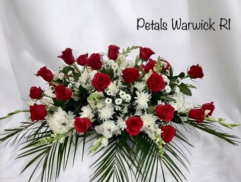 Red Roses &amp; White Casket Spray by Petals - Please allow 24 to 48 hours for this design so I can deliver your flower on time. If you need immediate delivery, contact me at 401-828-0701 for a telephone consultation today.  Honor your loved one with this spectacular Red Roses and White floral Casket Spray by Petals. Due to their vibrant red color, red roses have long been associated with love, symbolizing strong emotions. Designed with a beautiful array of Red and White Flowers. Some flower varieties may vary due to daily availability. Please call me at 401-828-0701 if you have a special request. Thank you, Cheryl