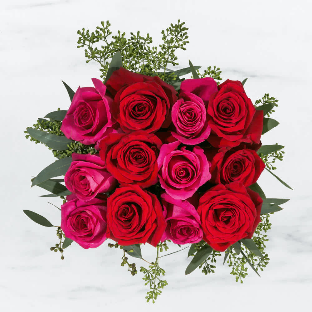 Sparks Fly by BloomNation™ - This rose combination is flirty, yet romantic. Sparks Fly by BloomNation™ the perfect gift for your first Valentine's Day.   Arrangement Details:  Standard includes a dozen roses in hot pink and red. Deluxe 18 Roses Premium 24 Roses APPROXIMATE DIMENSIONS: 10" H, 11" W, 11"L 