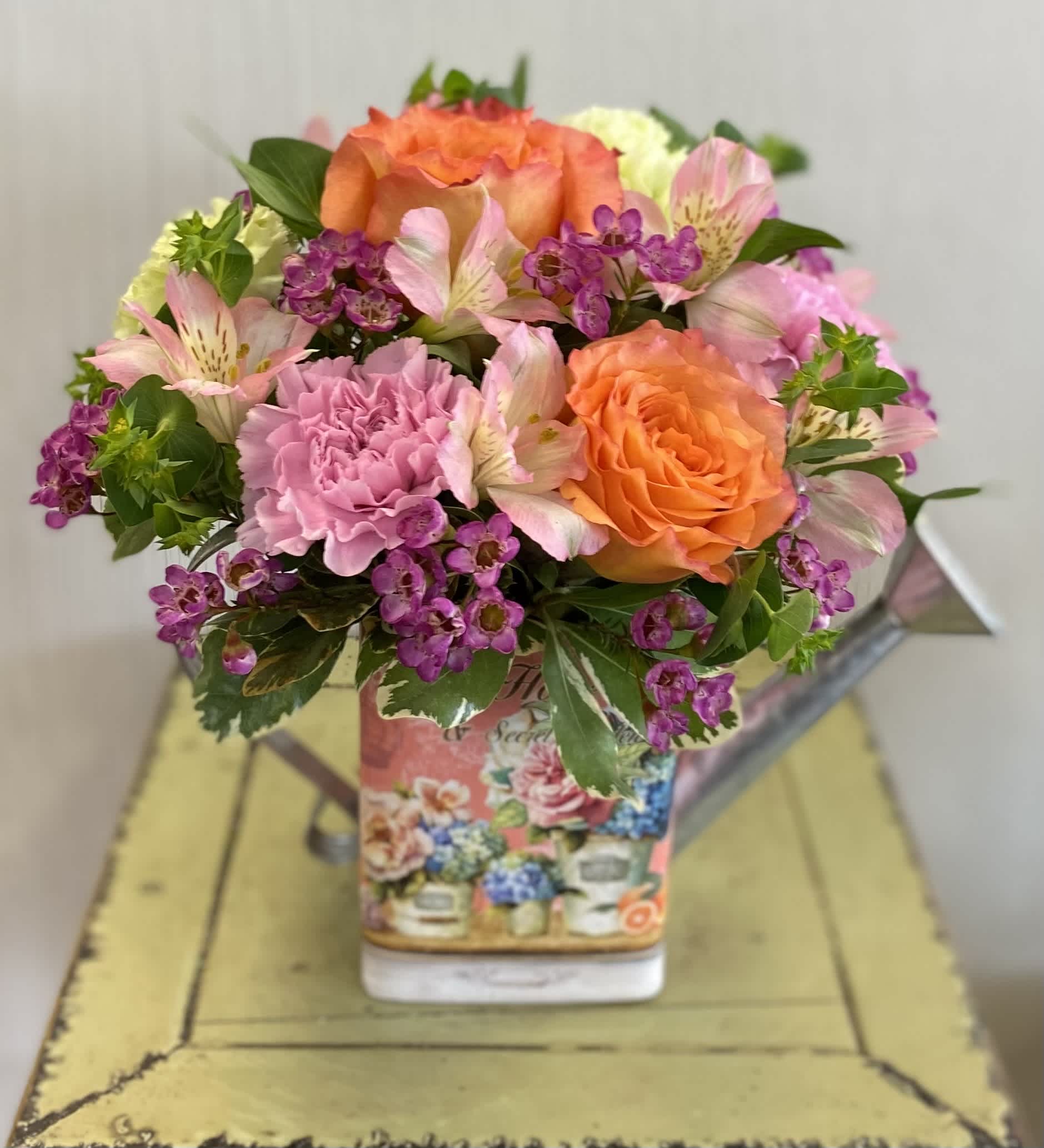 Country Garden Bouquet - A pretty floral tin bursting with vibrant spring colors. Roses, alstroemerias, and so much more! So, so pretty! Container may vary slightly.  
