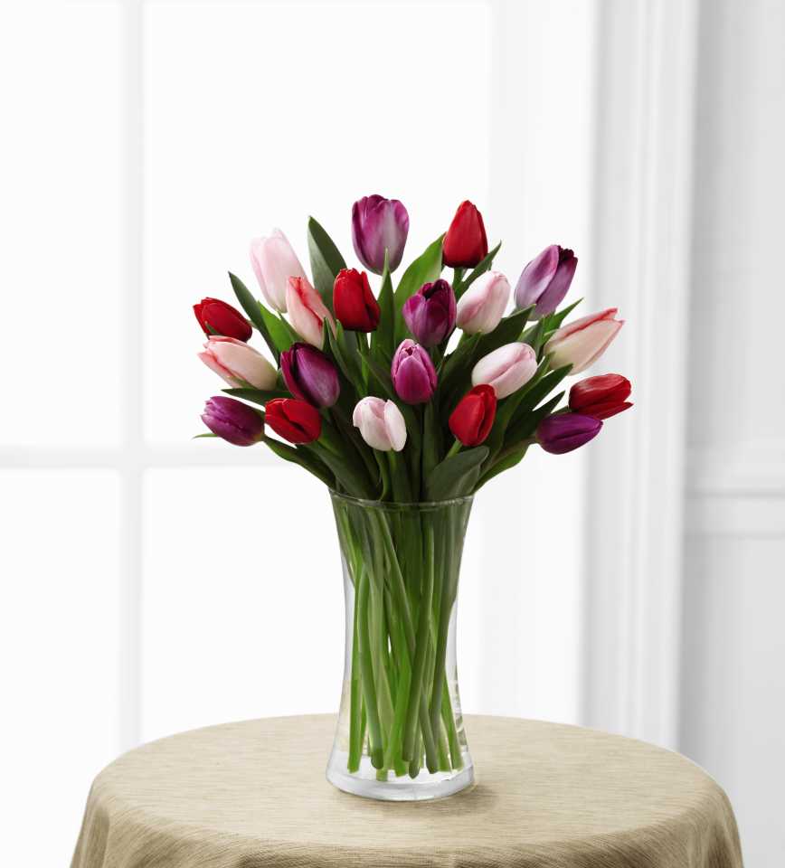 Carnival of Tulips Bouquet - Like all the busy commotion of a summer carnival, the riot of tones in this mix of tulips will surely cause a Spring awakening. All the gorgeous spring hues of the garden are captured in this cacophony of color! DELIVERY TO OUT OF TOWN destinations must meet higher minimum prices. Call for info.