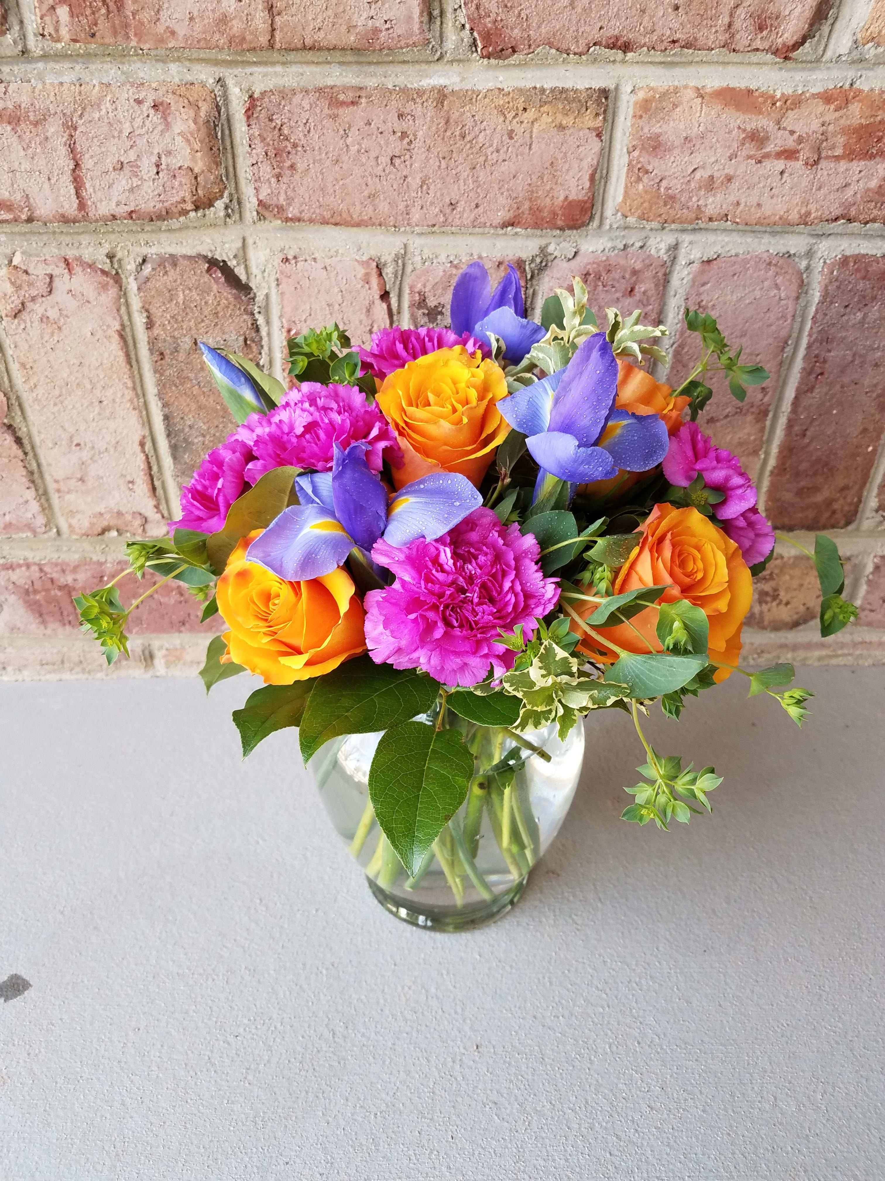 Brighten Your Day - A bright and vibrant arrangement that will brighten your special someone's day! *NOTE the Iris may not be in full bloom at the time of delivery. It will bloom in full over time to give you a lasting, colorful arrangement. 