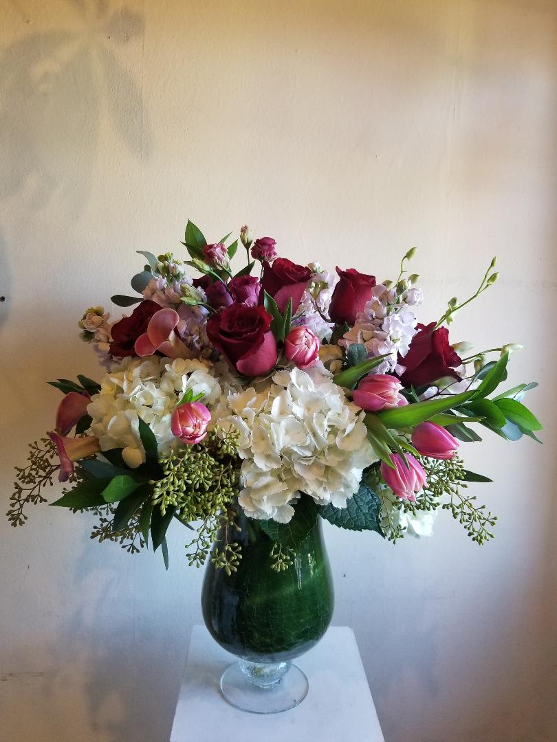 Kisses and Roses - A mixture of pink, red and white flowers, including roses, hydrangea, stock, tulips and accompanying flowers. (please leave notes in special instructions for color changes)