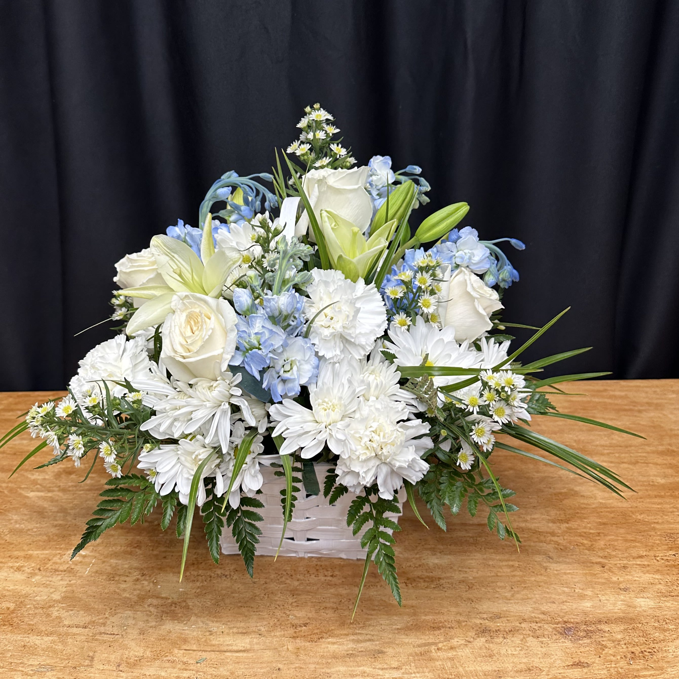 Eternal Remembrance Blue and White - Your message perfectly encapsulates the sentiment behind this arrangement. It's a beautiful expression of love and devotion, crafted with care and attention to detail. The combination of delicate blooms and elegant presentation truly creates a heartfelt tribute to the special bond shared with a loved one.    