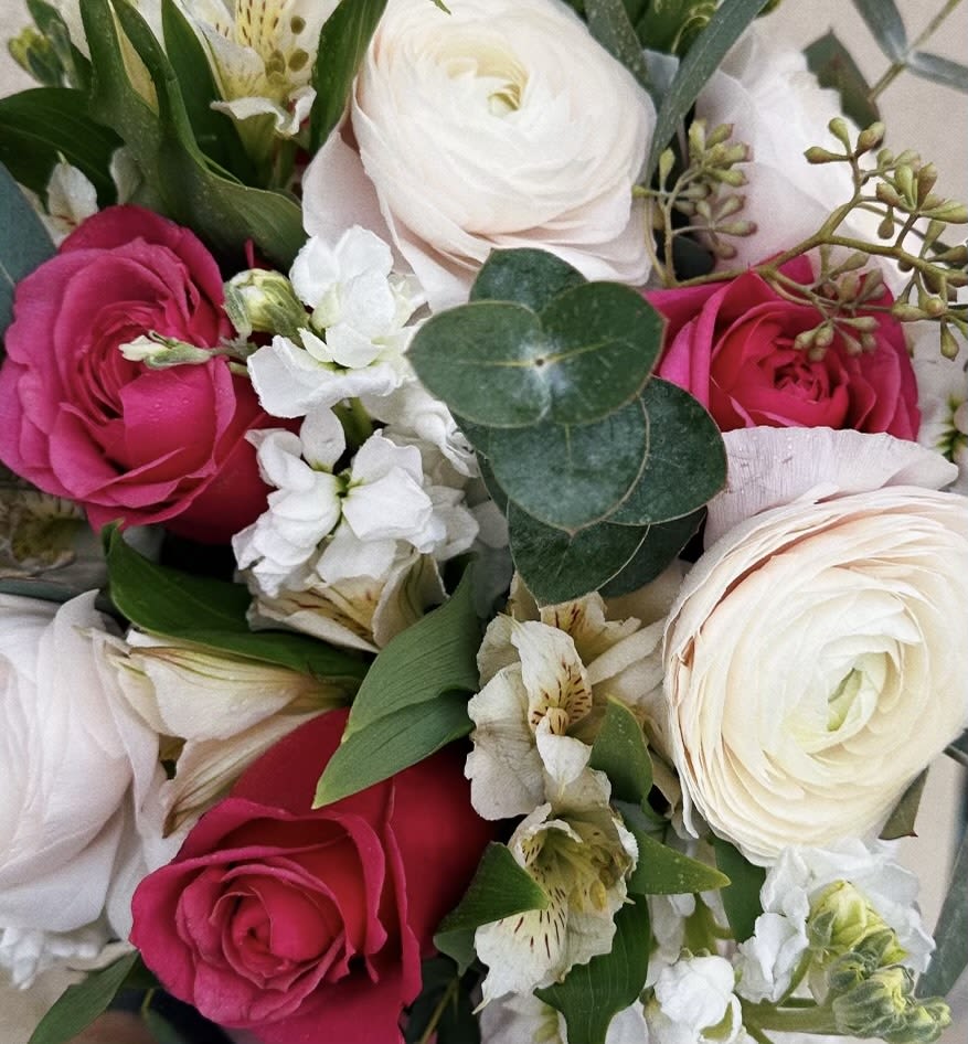 Shades of Pink Bouquet - Assorted florals in shades of pink, peach and cream in a wrapped bouquet. Each design is unique, and flowers may vary based on seasonal availability. This does not include a vase.