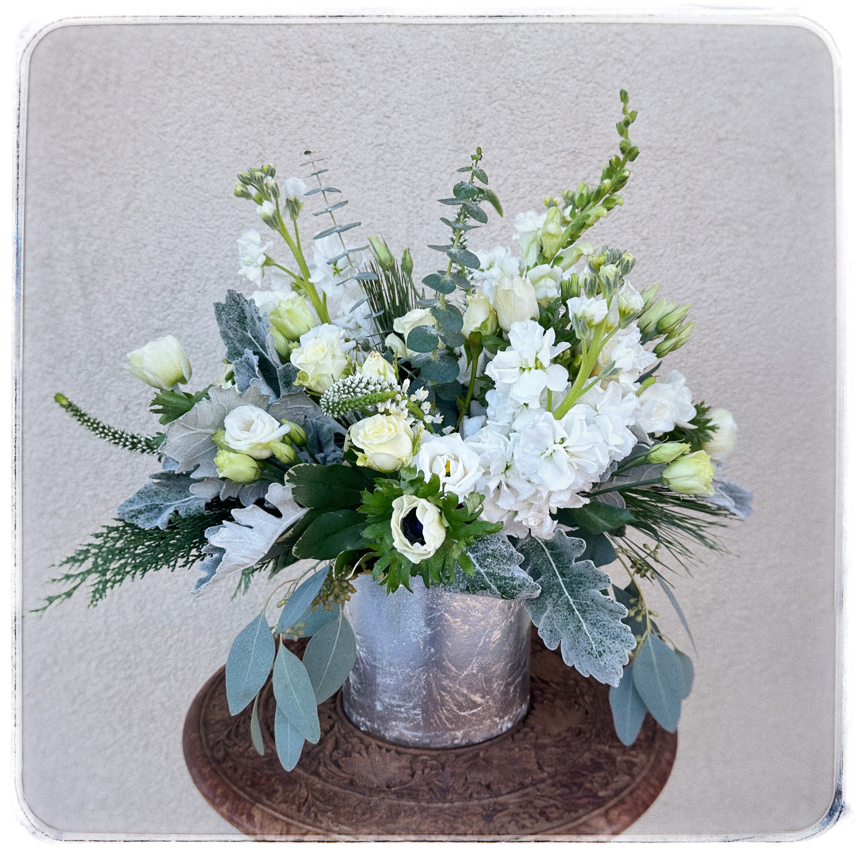 Silver Bells - This is an all white arrangement in a silver cyinder.