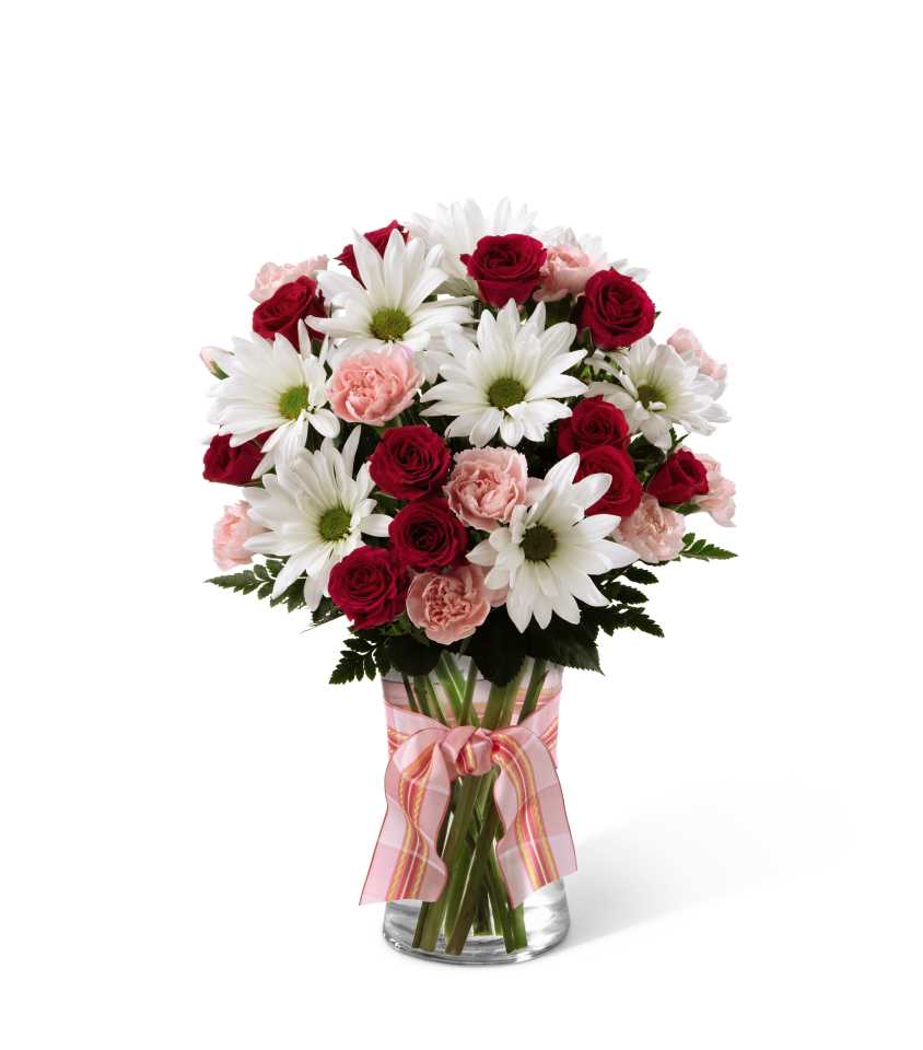 The FTD Sweet Surprises Bouquet - The FTD Sweet Surprises Bouquet is an absolutely charming way to send your warmest sentiments. Deep fuchsia spray roses, pink mini carnations, white traditional daisies and lush greens are sweetly situated in a classic clear glass vase accented with a perfectly pink designer ribbon to create a bouquet that will delight your special recipient at every turn. GOOD bouquet includes 8 stems. Approx. 14âH x 10âW. BETTER bouquet includes 13 stems. Approx. 15âH x 11âW. BEST bouquet includes 20 stems. Approx. 16âH x 12âW.