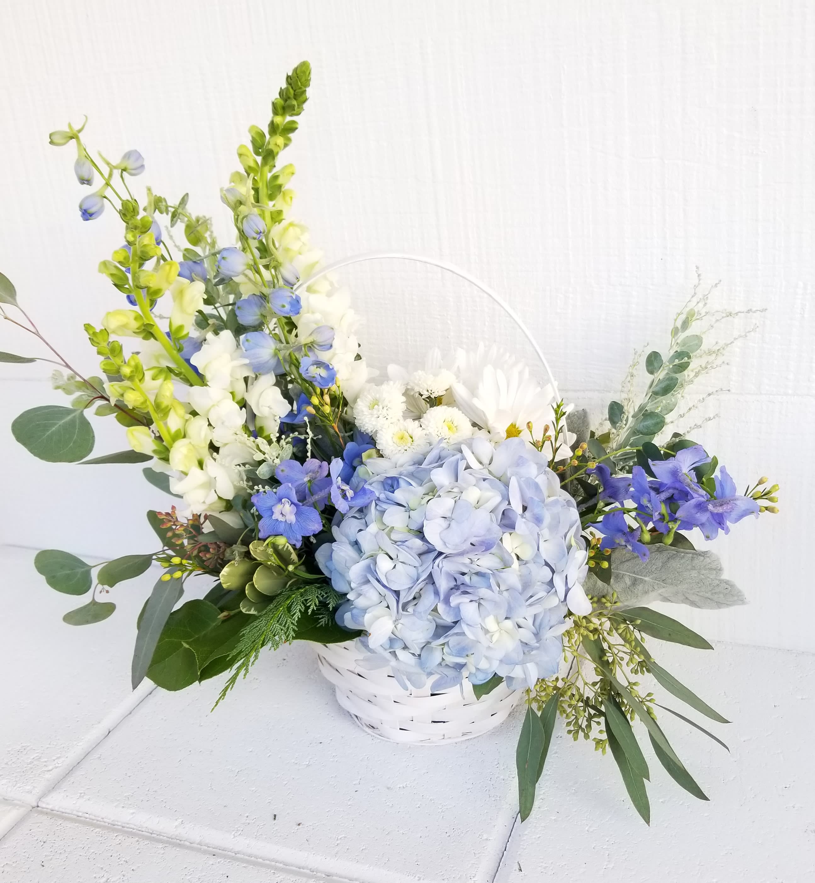 Touch of blue basket - Soft blues and whites in an elegant design.   Upgrades go in a bigger basket for a fuller design. 