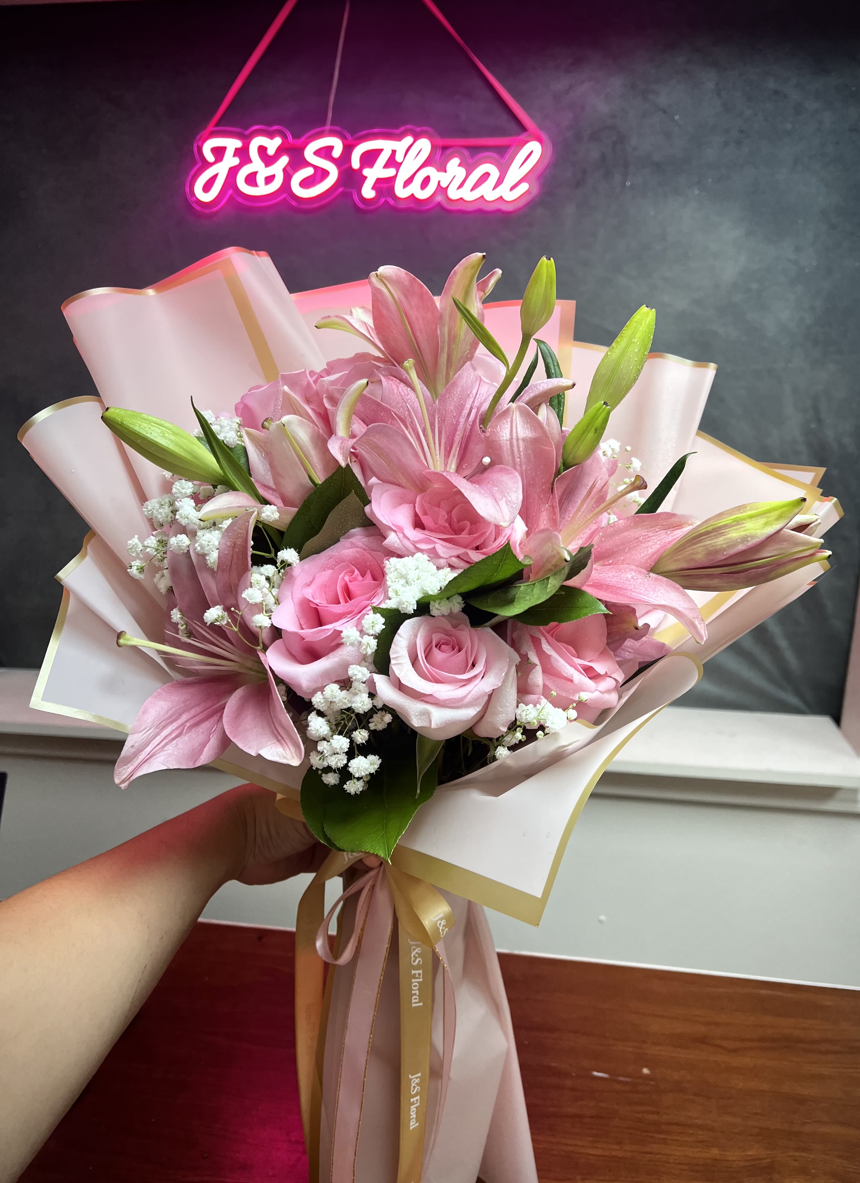 Blush Elegance Bouquet  - The Blush Elegance Bouquet features a delicate blend of pink lilies and pink roses, artfully arranged to create a soft, romantic display. Perfect for expressing love, admiration, or celebrating special moments, this bouquet brings a touch of elegance and charm to any setting.
