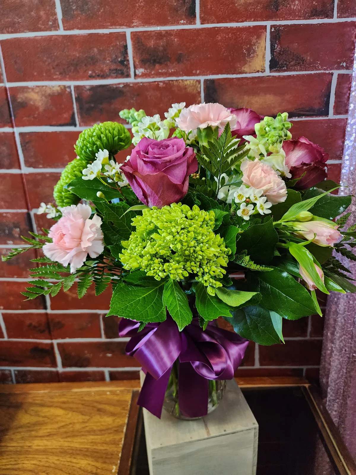 Shades of Pink and Green - Designed with pink roses, pink snaps pink alstromeria, light pink carnations, lime green spider mums, green hydrangea, greenery and filler flowers. This all around bouquet might include eucalyptus amongst the greenery.  * Some stages of flower life may vary. (Example: Lilies may be more open than imaged.)  Flower shortages and product availability means that some substitutions will apply. Value will always be filled. This bouquet might include eucalyptus amongst the greenery. It may be toxic to pets including but not limited to cats and dogs if digested.