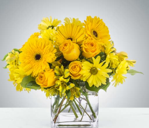 Lemonade by BloomNation™ - This monochromatic arrangement can make anybody feel a little more cheerful. Lemonade by BloomNation™ lifts the spirits and makes you think of good old times. A perfect gift to send to somebody who needs a little extra joy in their life.  Approximate Dimensions: 12"D x 10"H