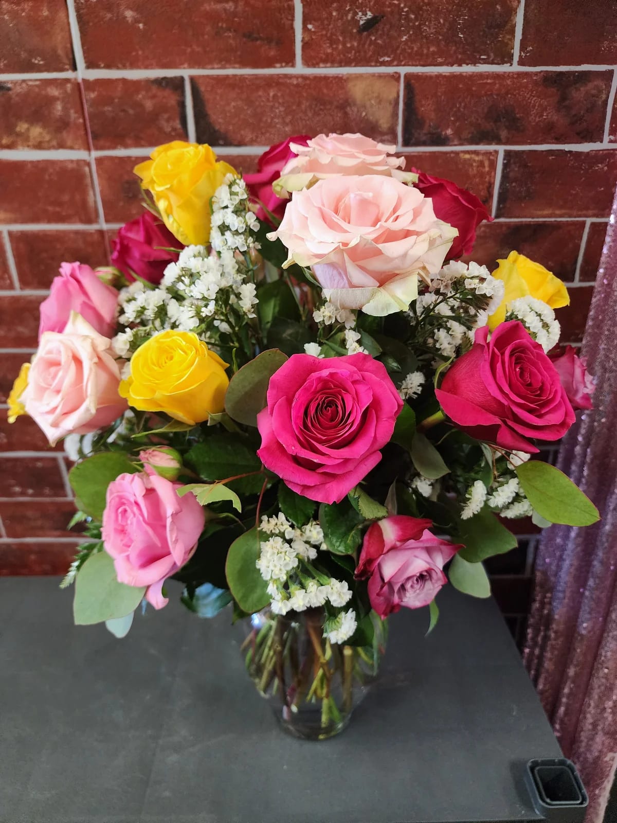 Mixed Dozen Roses - Designed with 1 dozen fresh roses in an assortment of colors, greenery and filler flowers. This all around bouquet might include eucalyptus amongst the greenery.  * Some stages of flower life may vary. (Example: Lilies may be more open than imaged.)  Flower shortages and product availability means that some substitutions will apply. Value will always be filled. This bouquet might include eucalyptus amongst the greenery. It may be toxic to pets including but not limited to Cats and Dogs if digested.