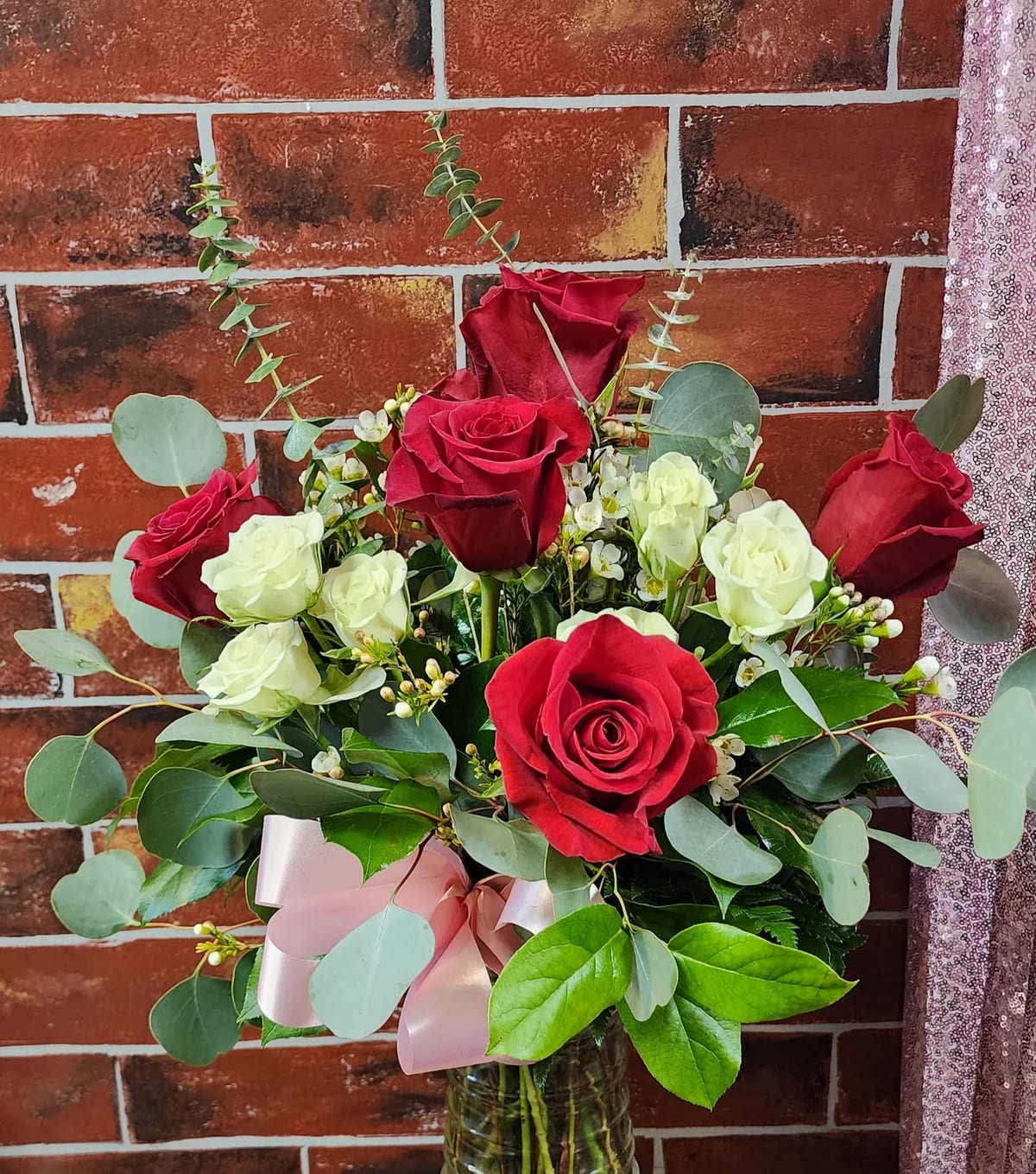 My Love - Designed with 1/2 dozen red roses with 3 white spray roses, greenery and filler flowers. This all around bouquet might include eucalyptus amongst the greenery.  * Some stages of flower life may vary. (Example: Lilies may be more open than imaged.)  Flower shortages and product availability means that some substitutions will apply. Value will always be filled. This bouquet might include eucalyptus amongst the greenery. It may be toxic to pets including but not limited to Cats and Dogs if digested.