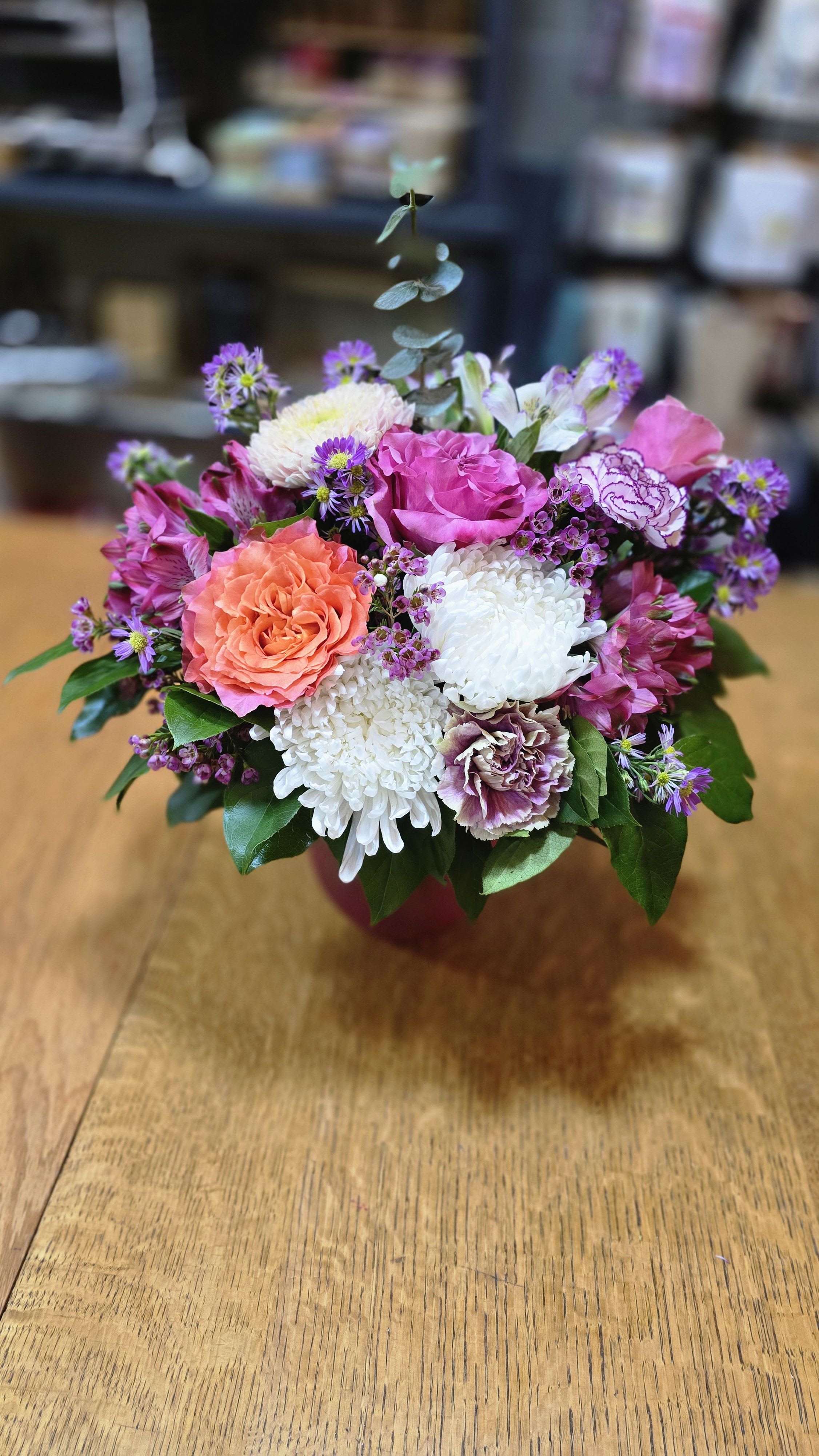 Pick Me Up - This bouquet is for all those who are feeling the moody blues. Purple and pink flowers in a variety of shades with a free spirit creating a bright spot amongst the bouquet. White cremones add a classic touch.   *Some stages of flower life may vary. (Example: Lilies may be more open than imaged.)  Flower shortages and product availability means that some substitutions will apply. Value will always be filled.  This bouquet might include eucalyptus amongst the greenery. It may be toxic to pets including but not limited to Cats and Dogs if digested.