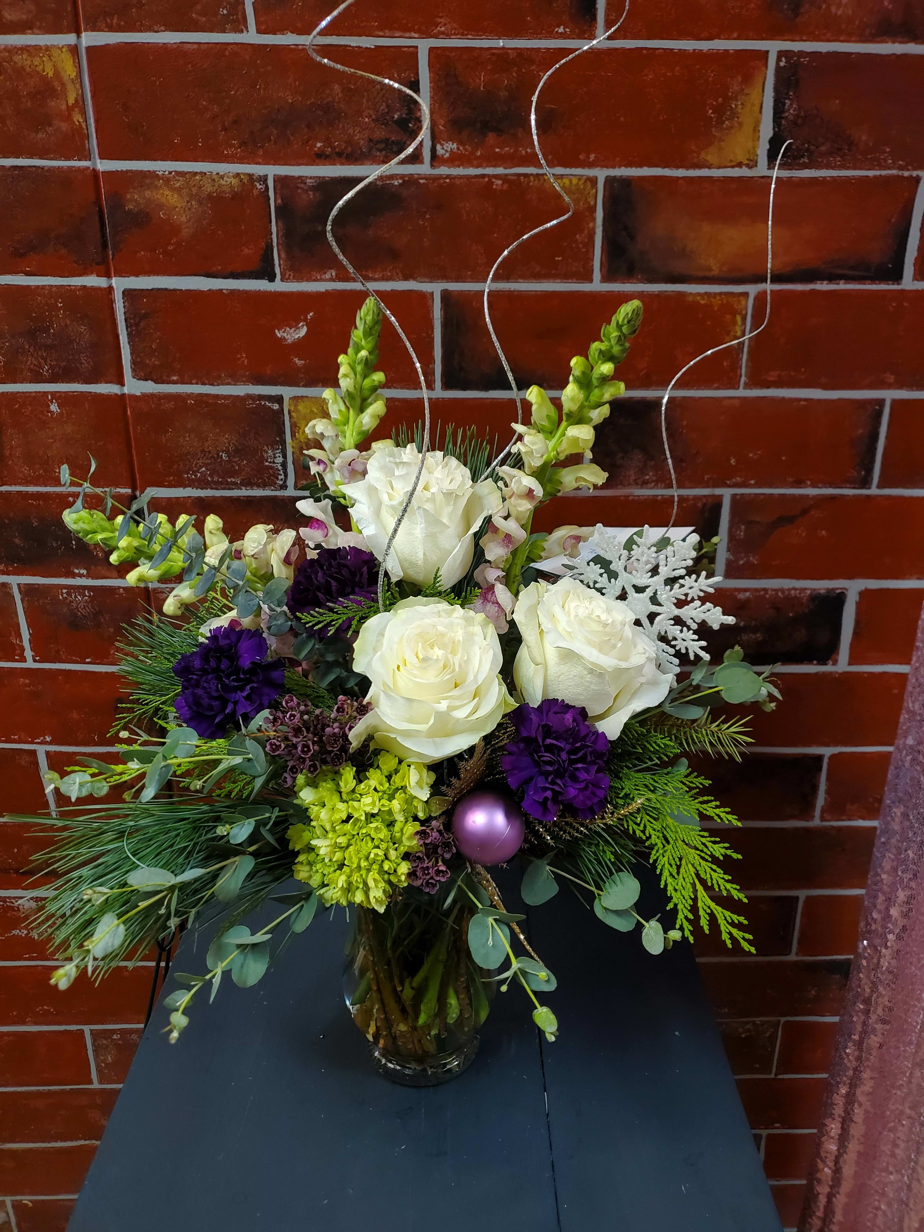 Retro Christmas Bouquet - Christmas themed bouquet   * Some stages of flower life may vary. (Example: Lilies may be more open than imaged.)  Flower shortages and product availability means that some substitutions will apply. Value will always be filled. This bouquet might include eucalyptus amongst the greenery. It may be toxic to pets including but not limited to Cats and Dogs if digested.