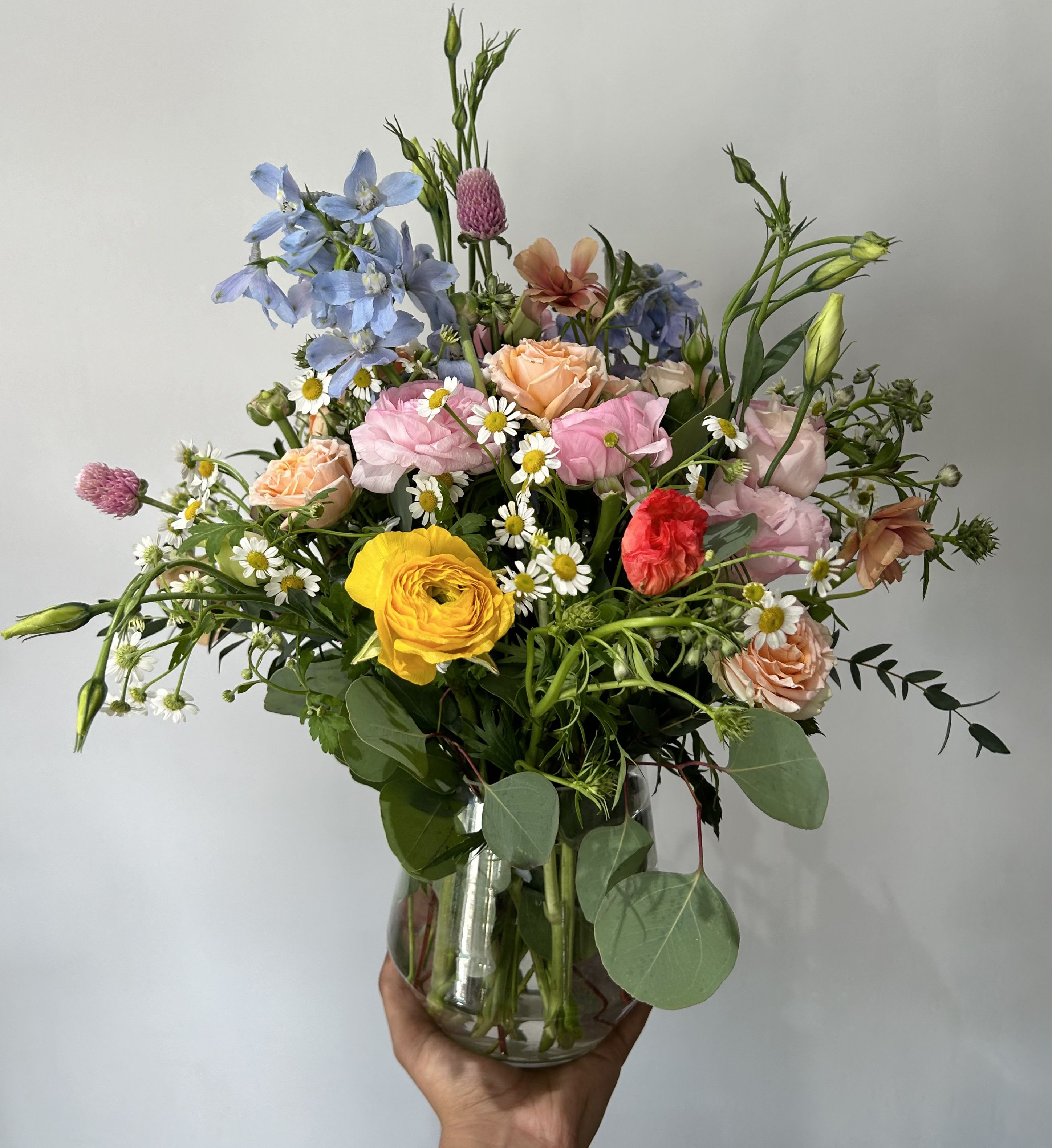 Spring's Arrival - Seasonal mixed flowers arranged into a vase. 